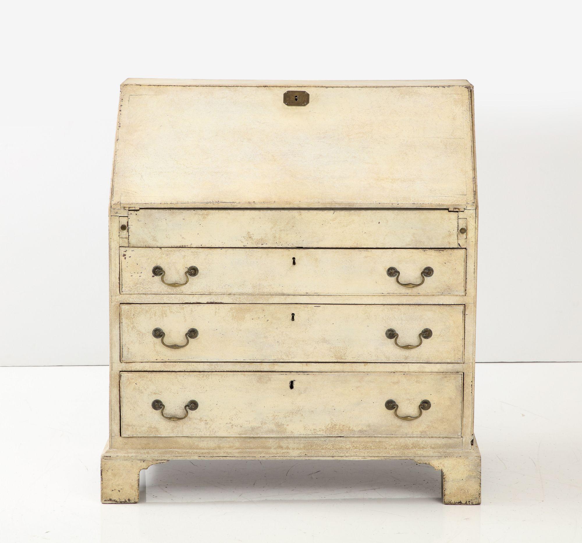 This late 19th-century French secretary exudes timeless elegance with its creamy painted finish. Its writing surface boasts a faux marble pattern, a lovely feature of French furniture from the era. When opened, the secretary reveals a functional