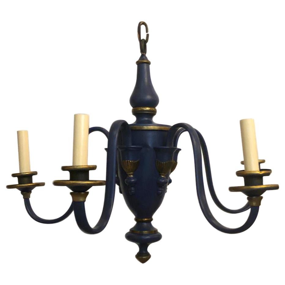 A circa 1930s French painted tole chandelier with gilt details.

Measurements:
Minimum drop 20