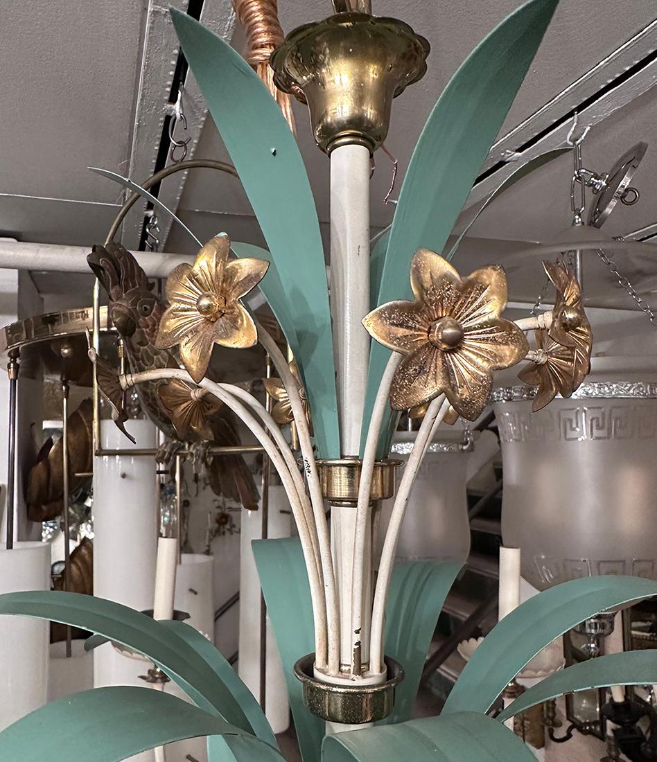 A circa 1960's French painted tole chandelier with gilt flowers and leaves with 8 candelabra lights.

Measurements:
Diameter: 46.5