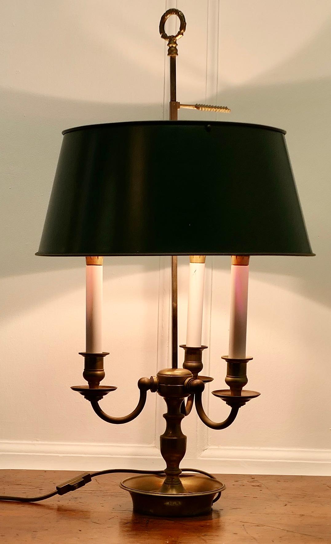 French Painted Toleware and Brass Triple Desk Lamp

A lovely piece, a brass triple sconce lamp with its original adjustable toleware shade 
A Very Traditional Design with three candles and the arrow shaped grip to adjust the shade
The shade is