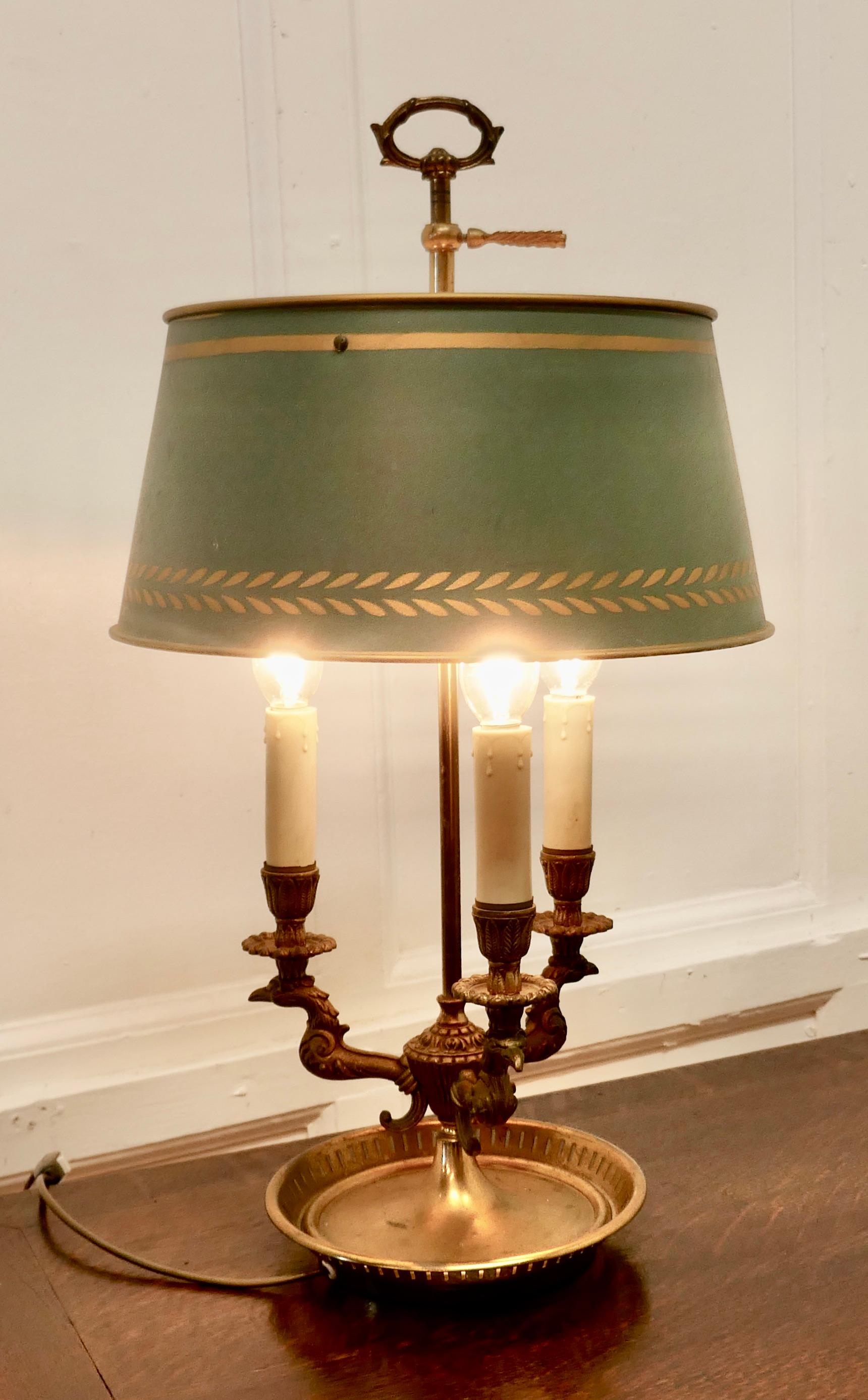 French Painted Toleware and Brass Triple Desk Lamp

A lovely piece, a brass triple sconce lamp with its original adjustable toleware shade 
A Very traditional design with three heads of a large bird presumably those who provide the quills and the