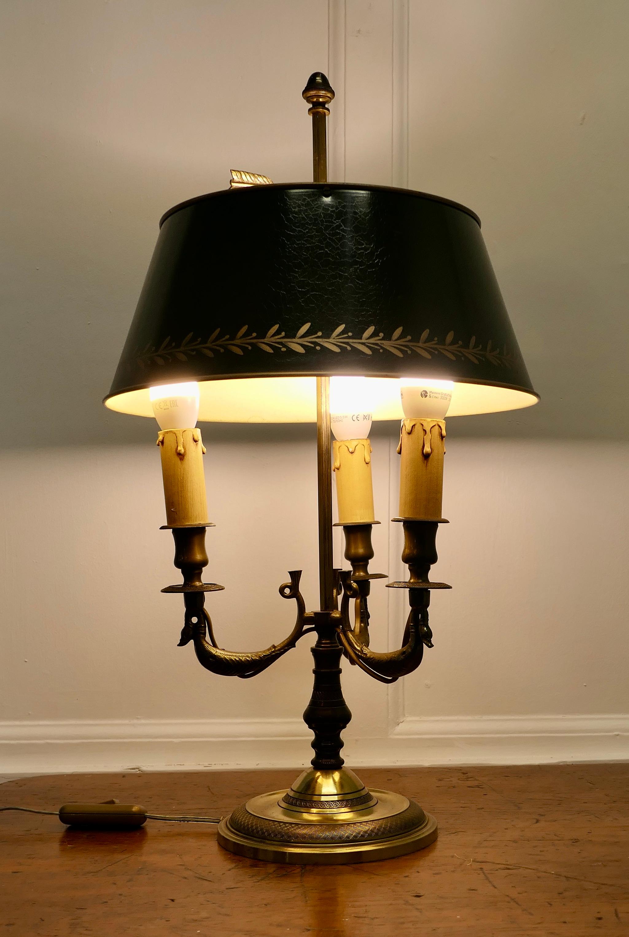 French Painted Toleware and Brass Triple Desk Lamp

A lovely piece, a brass triple sconce lamp with its original adjustable toleware shade 
A Very traditional design with three large birds presumably those who provide the quills and the arrow