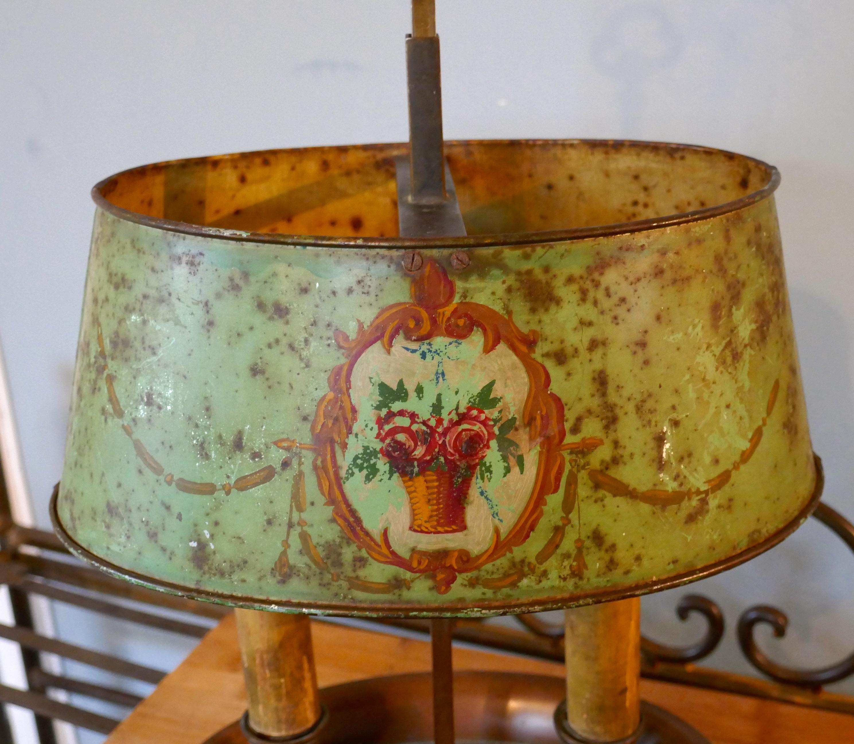 French painted toleware and brass twin table lamp

A lovely piece, converted from a toleware double candle stick, it is lovely to see an original shade like this one that is in its original (if Shabby) paint and has not been painted over
The