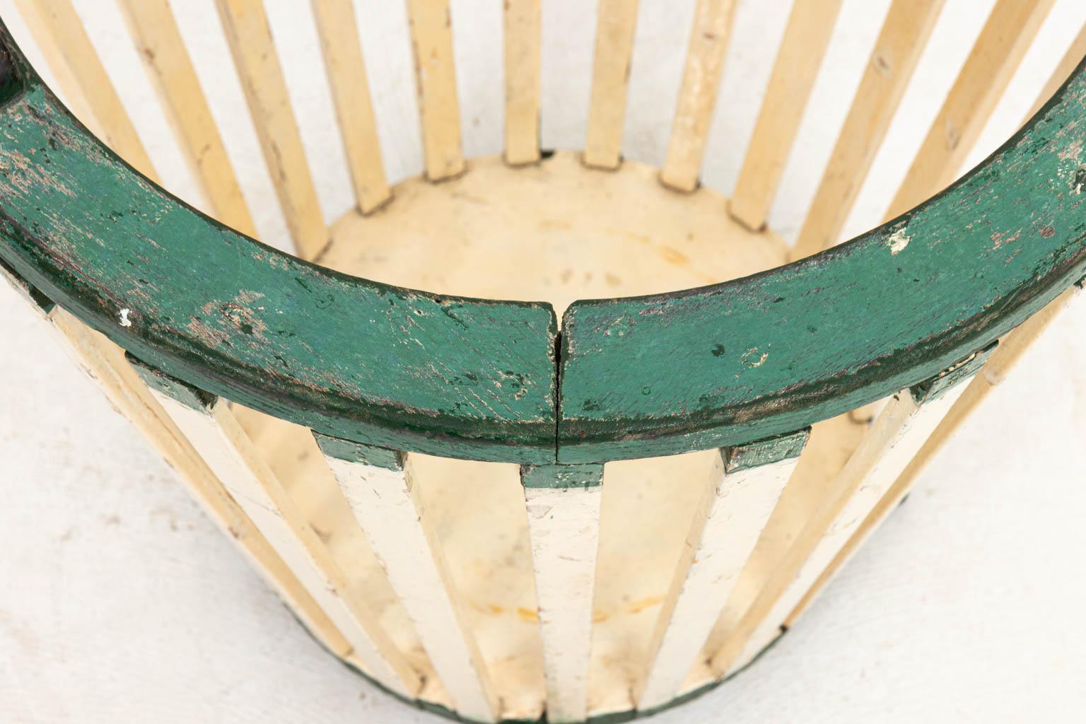French utility basket in original paint with handles and carved feet. Please note of wear consistent with age including heavy paint loss, finish loss, and wood loss.