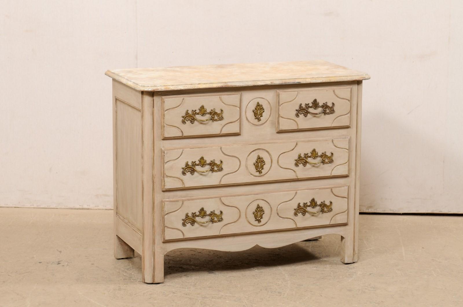 A French painted wood commode with faux marble top from the mid 20th century. This vintage chest from France has a rectangular-shaped marble top with rounded front corners, over case below which houses a pair of half-sized drawers at top, above two