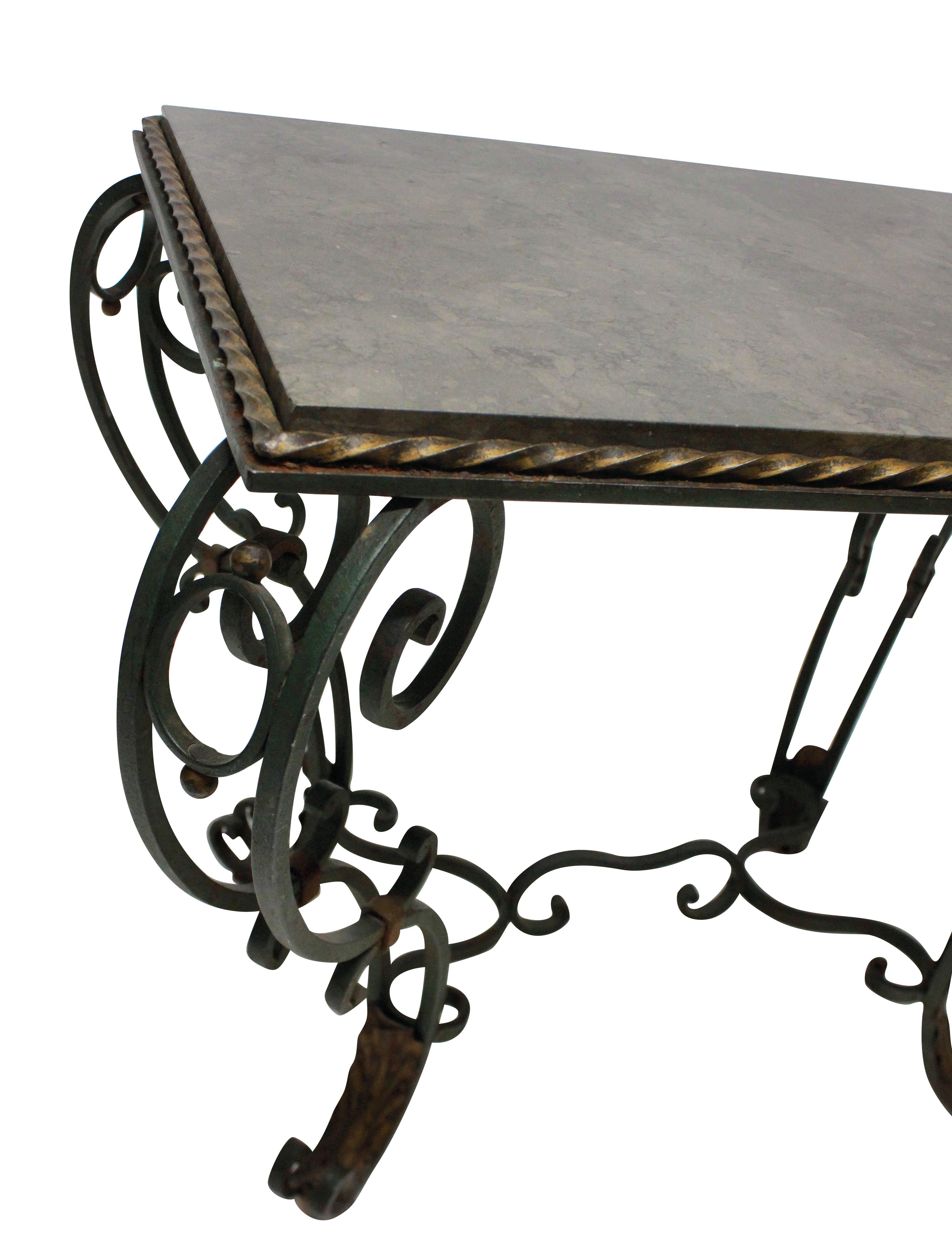 A French painted and gilded wrought iron occasional table with a polished blue-limestone top. The paint is a very dark green.