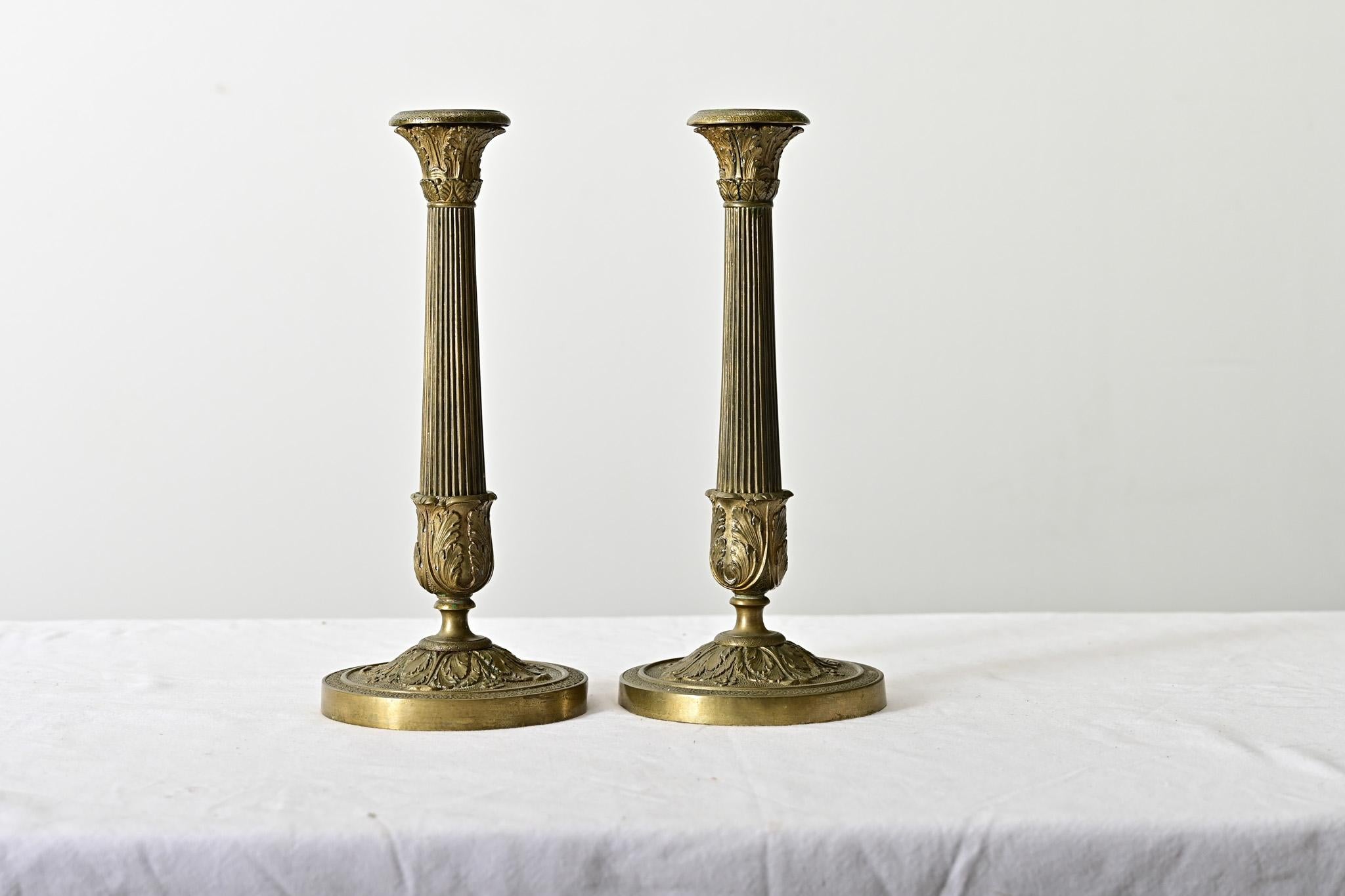 Exceptional quality French late 18th century brass candlesticks, Louis XVI-Directoire taste, like miniature Corinthian columns to add instant glamor to a mantel or table. Neoclassical inspiration is evident as fluted ridges surrounding the column,