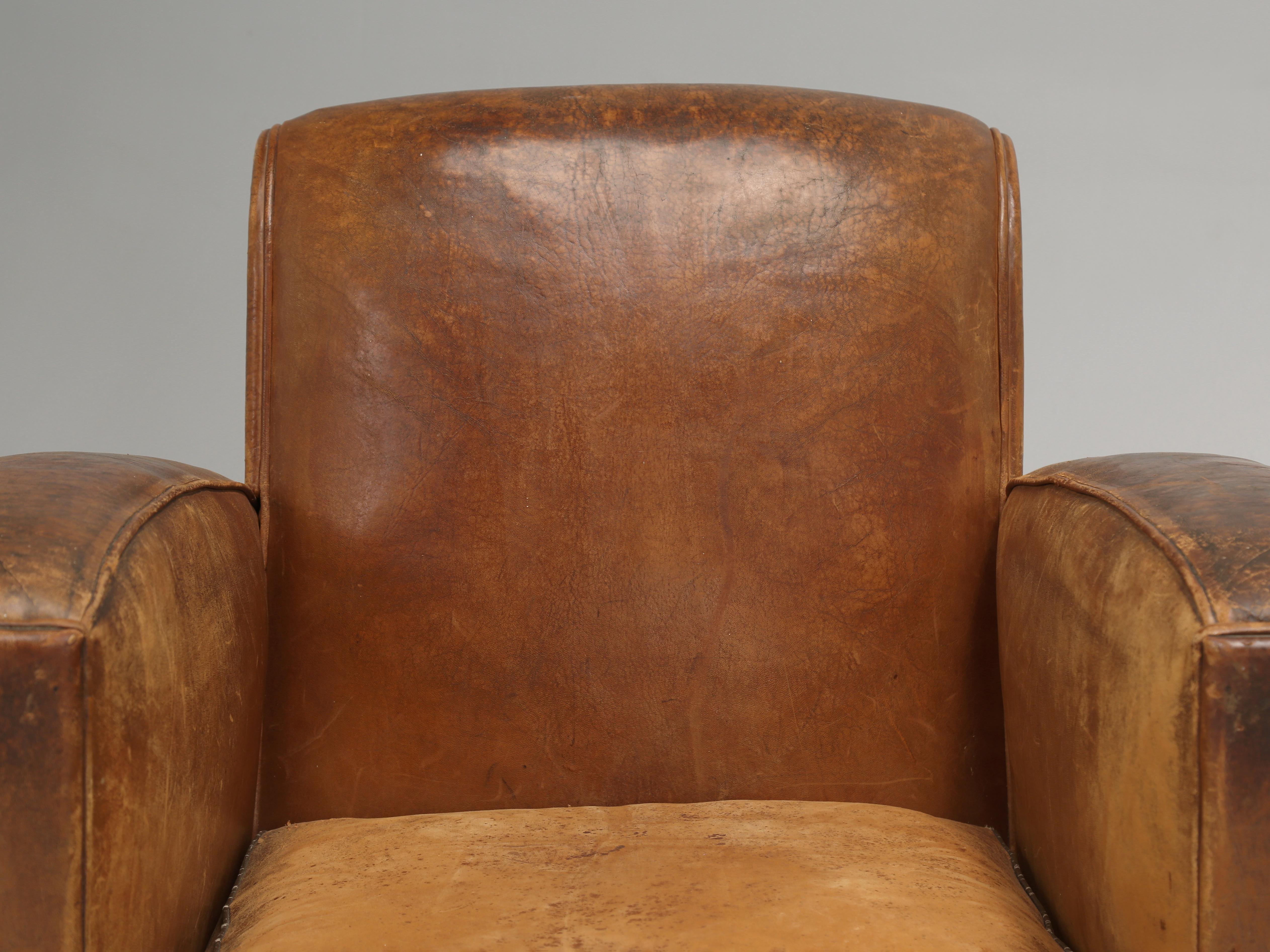 French Leather Art Deco Club Chairs Still in Original Leather. Our inhouse Old Plank Upholstery Department spent 80-Man-Hours completely disassembling the Pair of Matching French Leather Club Chairs in Restoring just the interiors of the Club