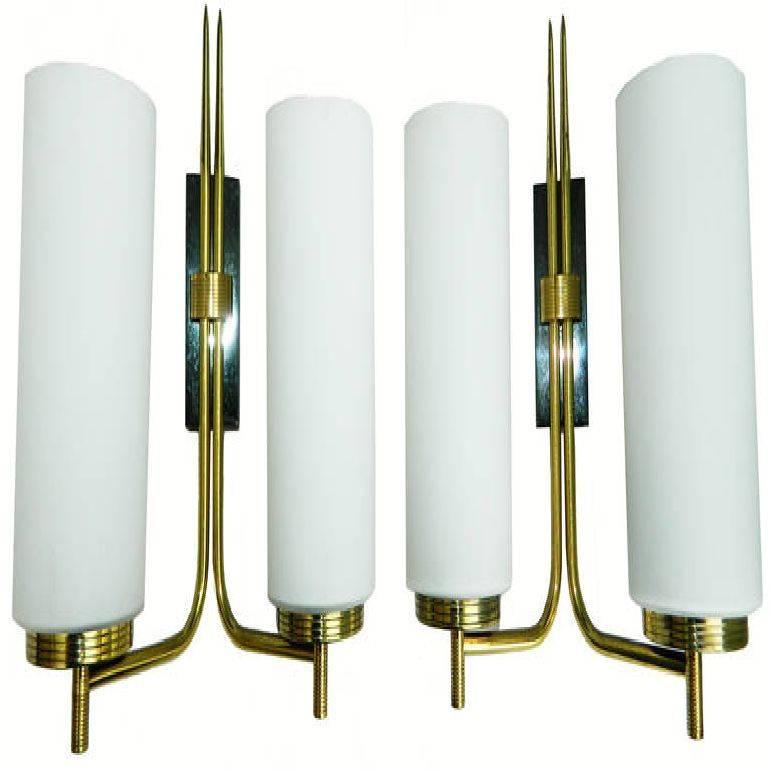 1960s pair of French sconces. Two patinas, gun metal and brass, original Opaline shades. US rewired, and in working condition 60 watts bulb max.
Have a look on our  largest collection of French and Italian Mid-Century period sconces, more than 500