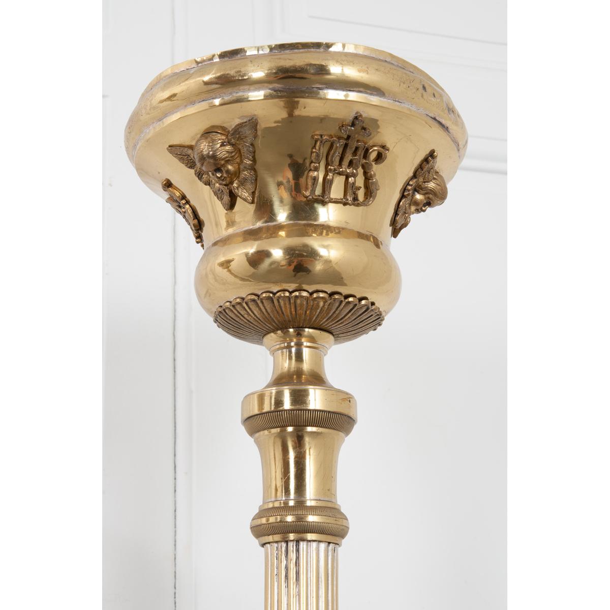 This delightful pair of French 19th century altar torches are made from sturdy wood and metal. Raised gilt brass ornamentation of cherubs and the initials IHS, which stands for Jesus, grace the top of the torches. At one time these would have been