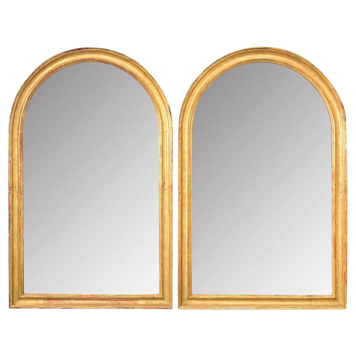 Pareja francesa de espejos dorados arqueados del siglo XIX en venta