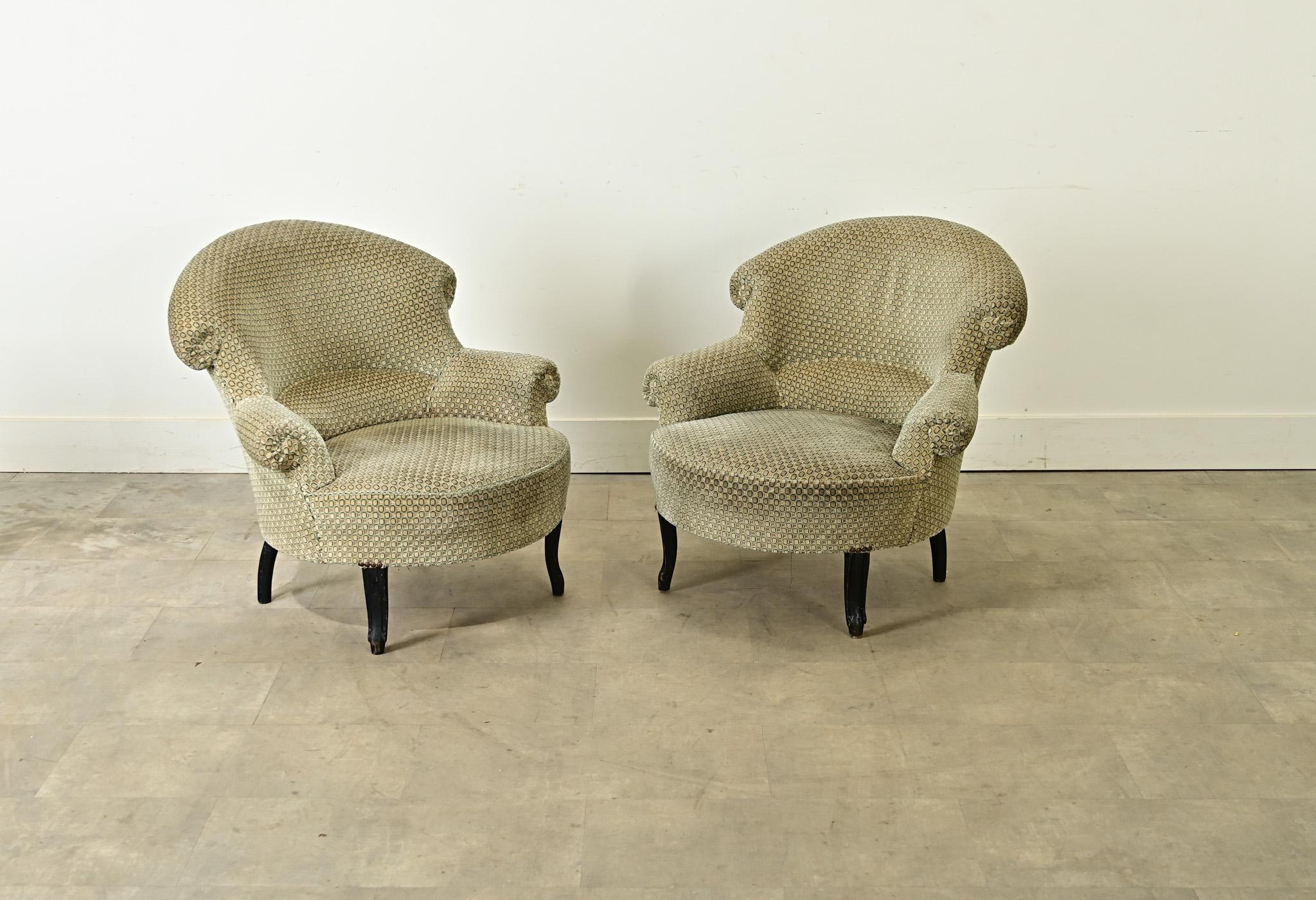 An inviting pair of French 19th century Napoleon III style armchairs that embody leisure and luxury in one design. Currently upholstered in a dotted velvet of cream and teal, these chairs offer the thoughtful proportions of a classic tub chair, with