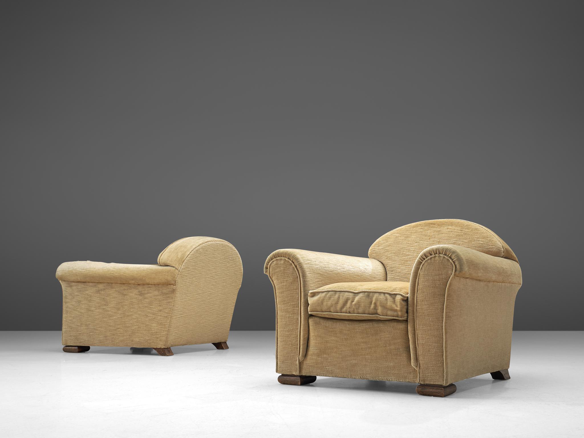 Pair of lounge chairs, fabric and oak, France, 1940s.

Wide and comfortable chairs in a soft beige velours upholstery. Truly extraordinary lounge chairs that feature a very deep seat and rounded armrests that are in the style of Rene Drouet. These