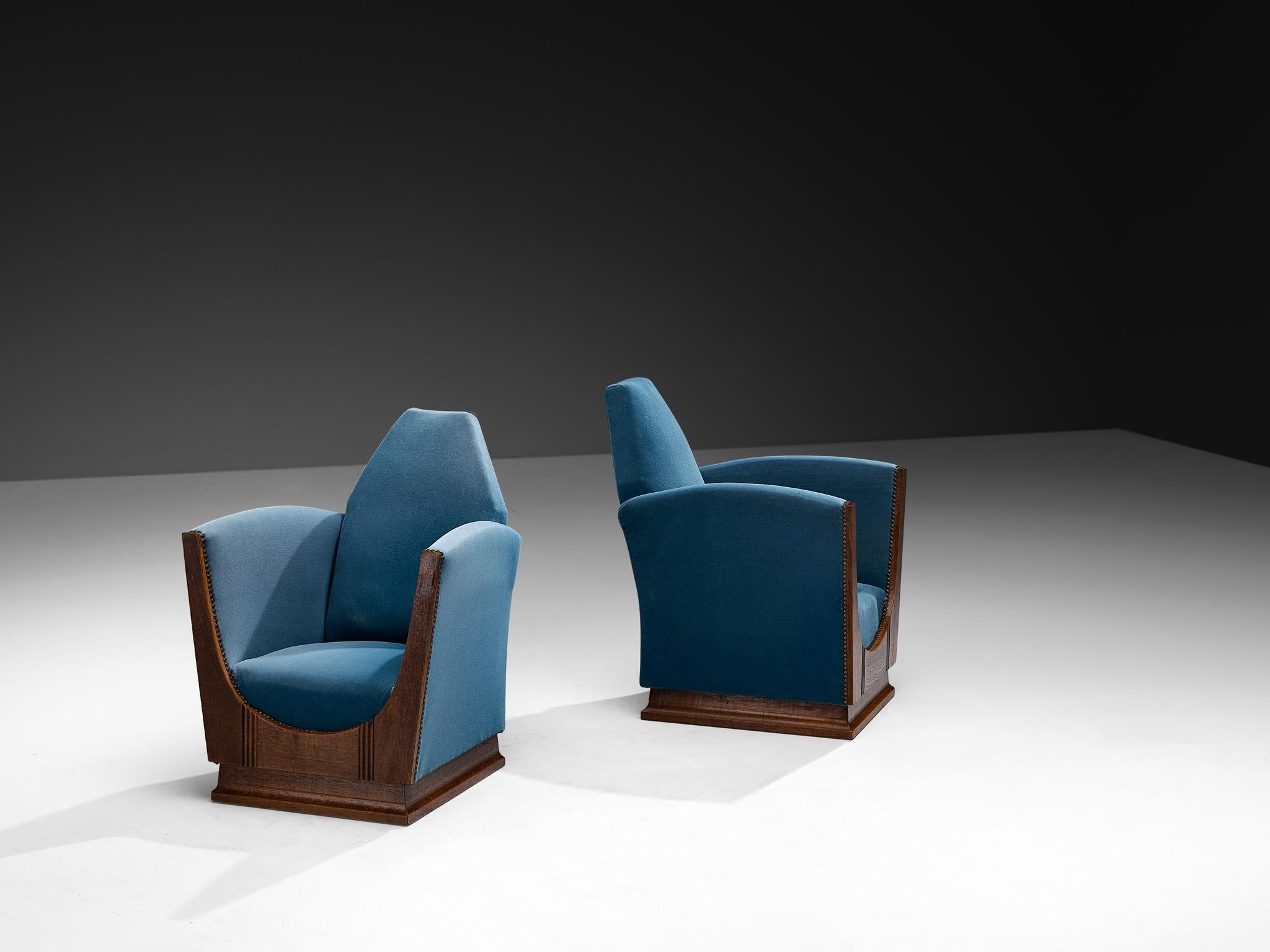 Pair of lounge chairs, velvet, oak, metal, France, 1920s

These 1920s French armchairs are striking examples of the Art Deco movement, but they also carry a strong undercurrent of the Amsterdamse School, especially in their sculptural quality and
