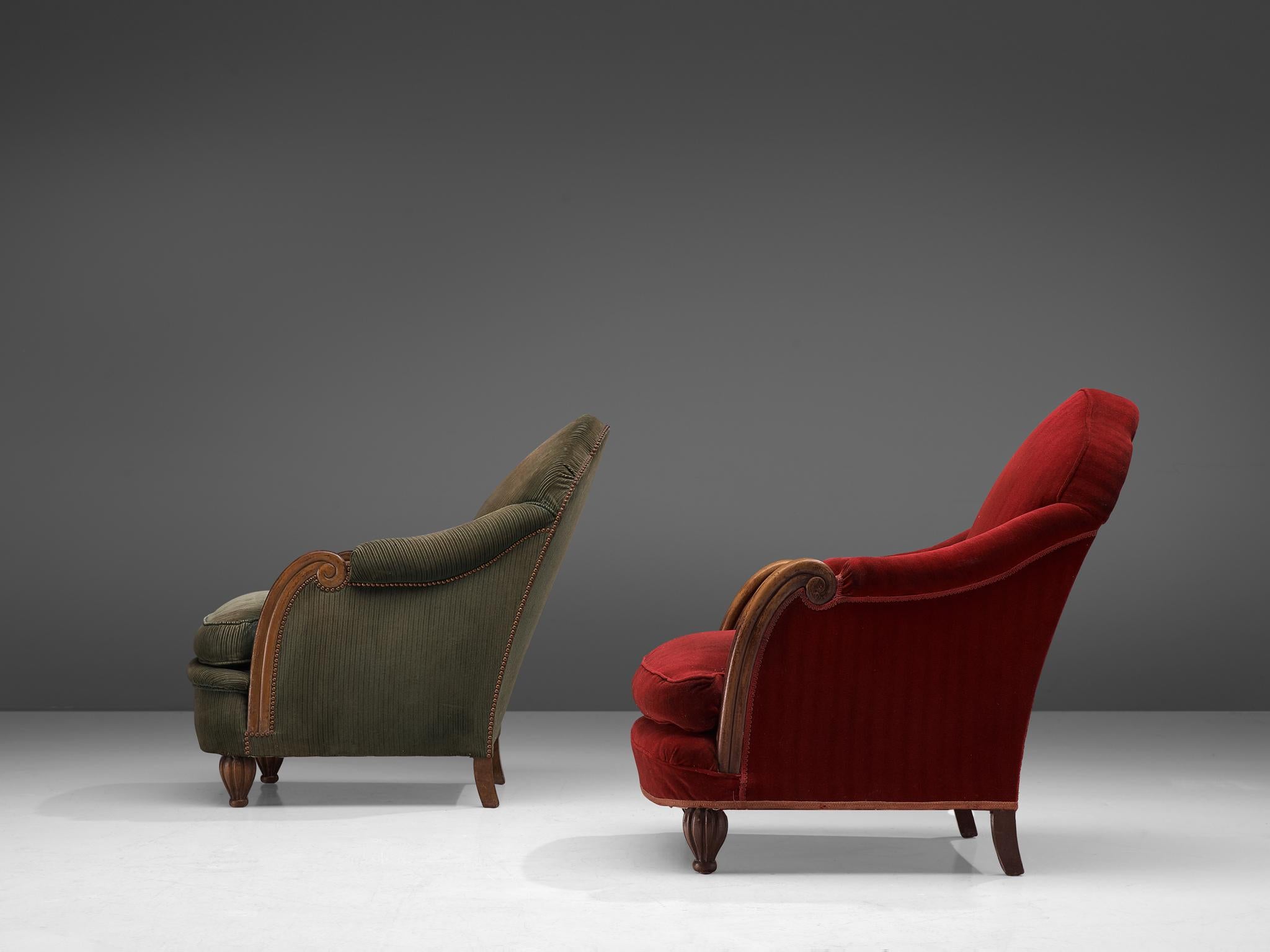 Lounge chairs, fabric and oak, France, 1930s-1940s.

These Art Deco lounge chairs feature a majestic, curved backrest with elegant, decorative armrests, and a voluptuous seat. The short legs are carved in a classical way. The voluptuous upholstery