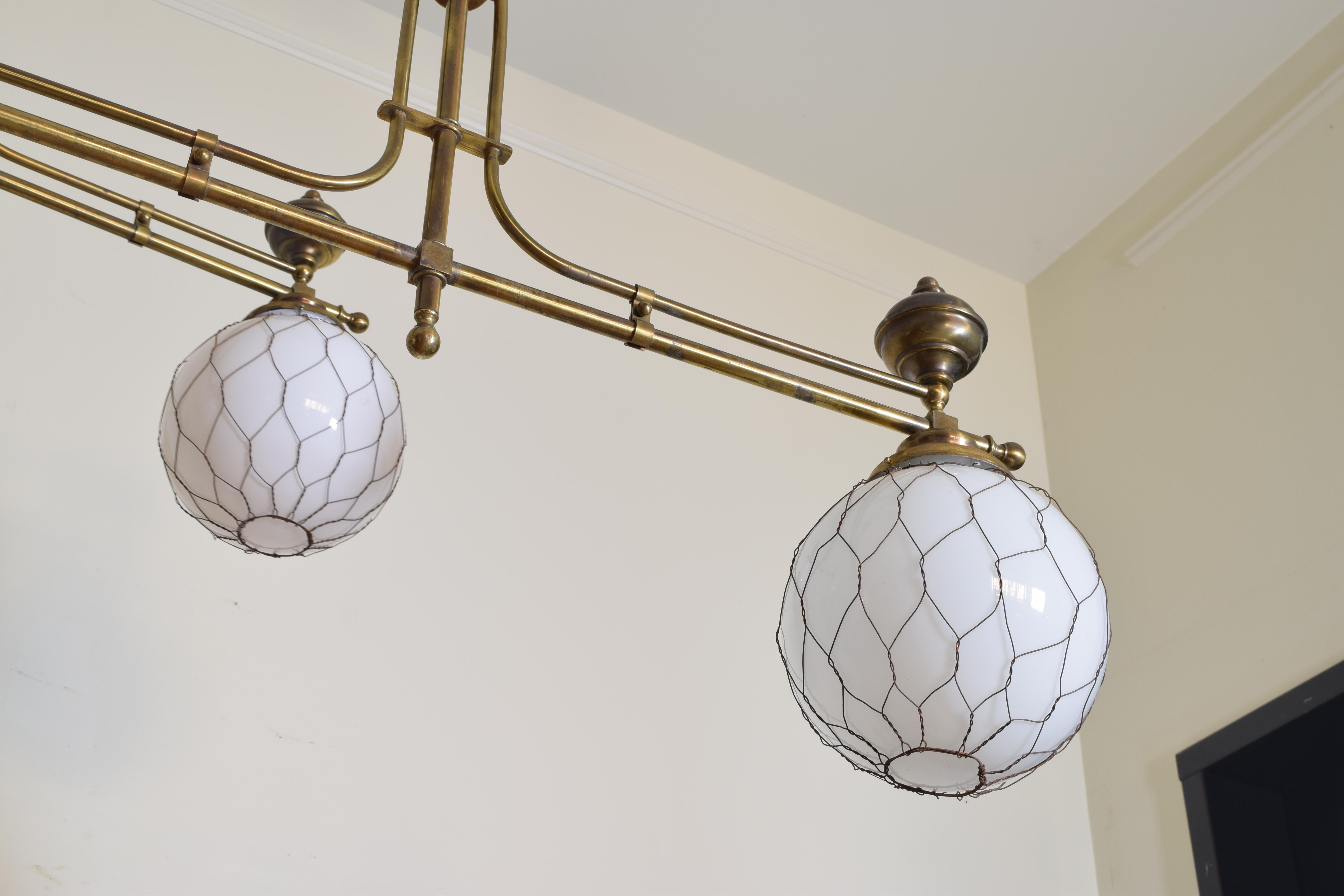 French Pair of Brass Bistro Globe Chandeliers, circa 1910, Now UL Wired In Good Condition In Atlanta, GA