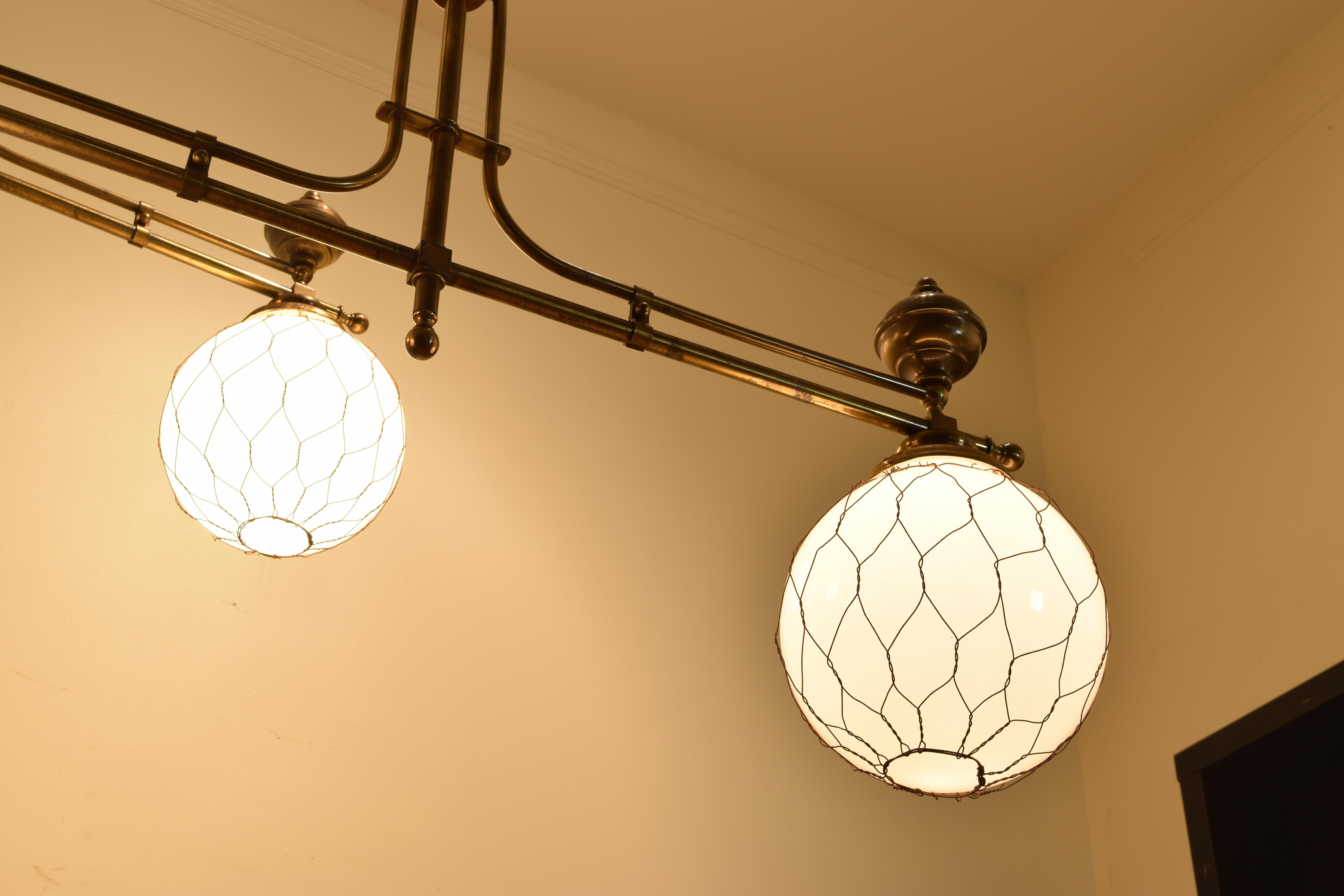 Early 20th Century French Pair of Brass Bistro Globe Chandeliers, circa 1910, Now UL Wired