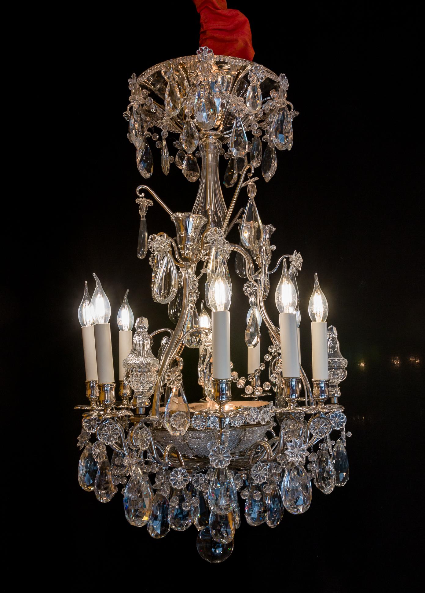 French pair of chandeliers by Baguès & Baccarat, silver-plate and cut crystal, circa 1880.

Amazing, rare, elegant and ornamental silver-plate pair of French chandeliers with nine elegantly scrolled arm lights and six internal lights. 
Our pair