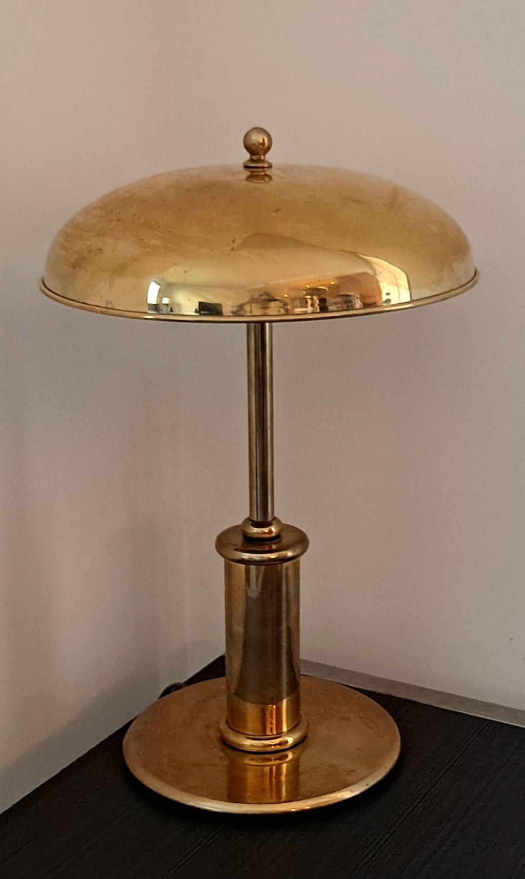 This Deco Brass table lamp from the 1950s  is a classic clean line table lamp with a high quality brass base and brass shade timeless design .