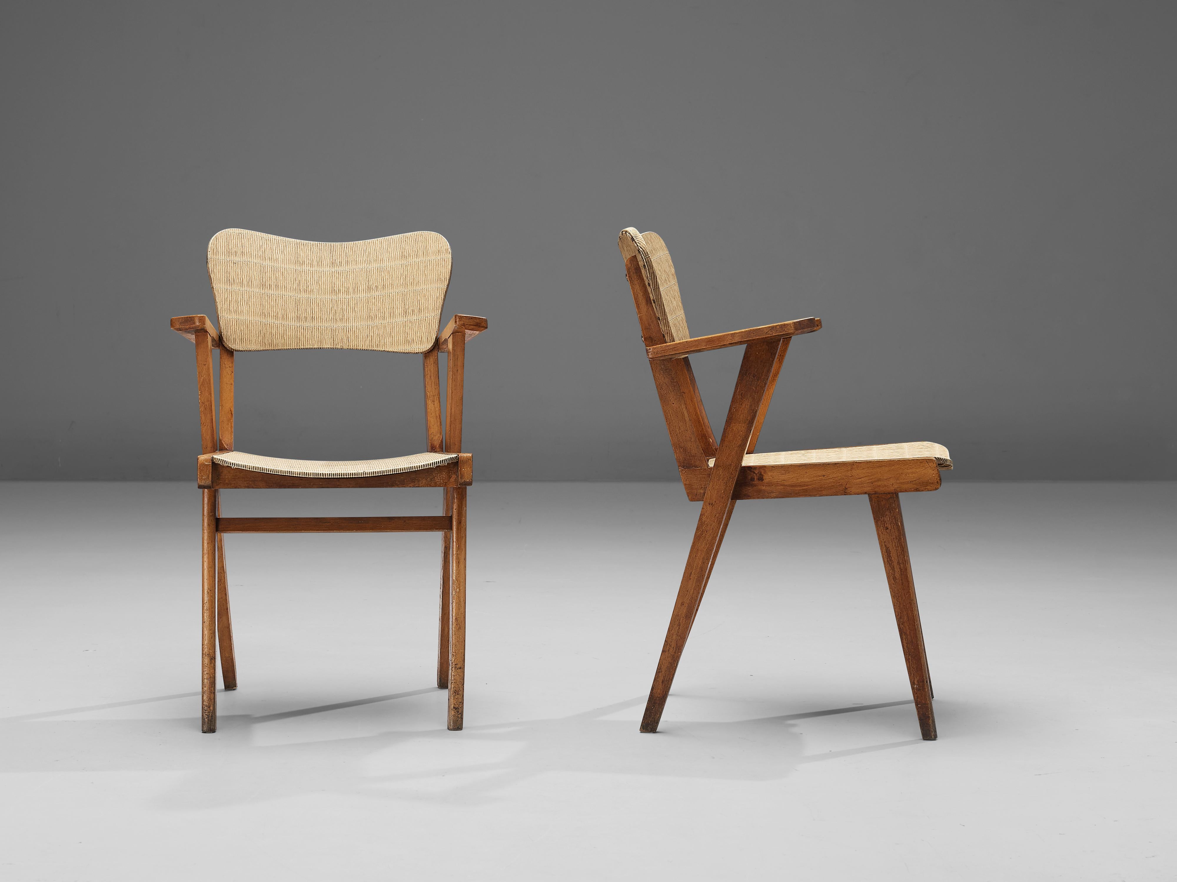 Pair of dining chairs, beech, vinyl, France, 1960s 

These dining chairs are characterized by a sculptural construction featuring sleek lines and geometrical shapes. The seating area and backrest are executed in a peculiar material called vinyl