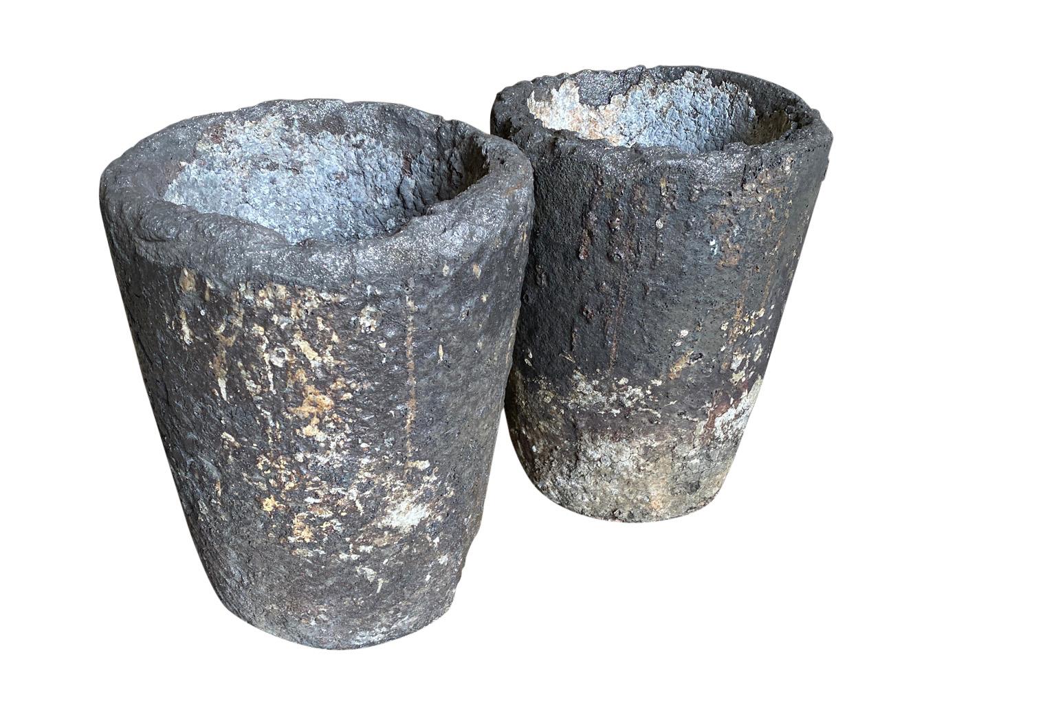 A terrific pair of early 20th century Creuzet - foundry Pots from France. Fabulous patina. Fabulous as jardinieres or planters. Perfect for any interior of garden. A crucible was made from a material with a much higher melting point than what was