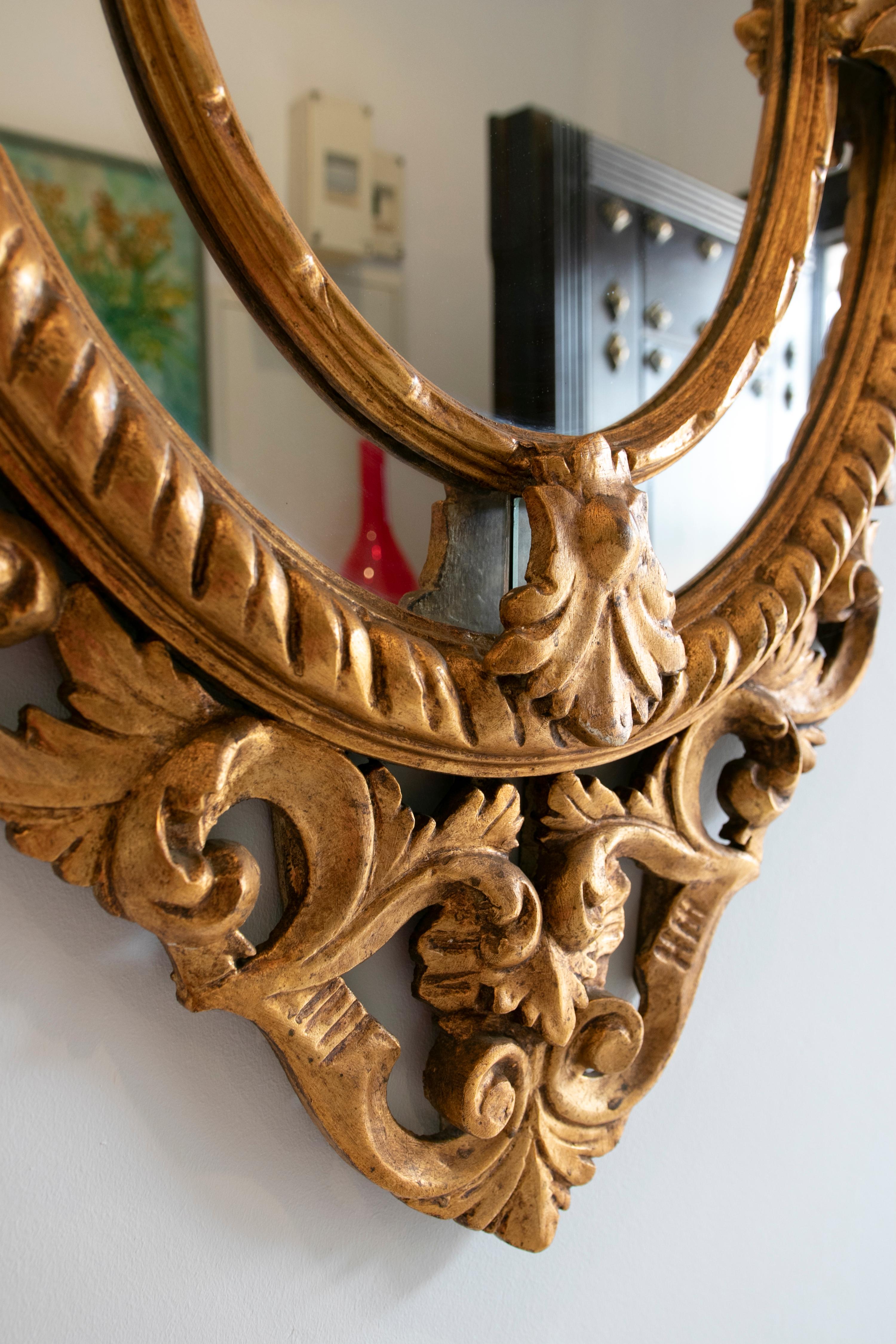 French Pair of Hand-Carved oval-shaped gilded mirrors.