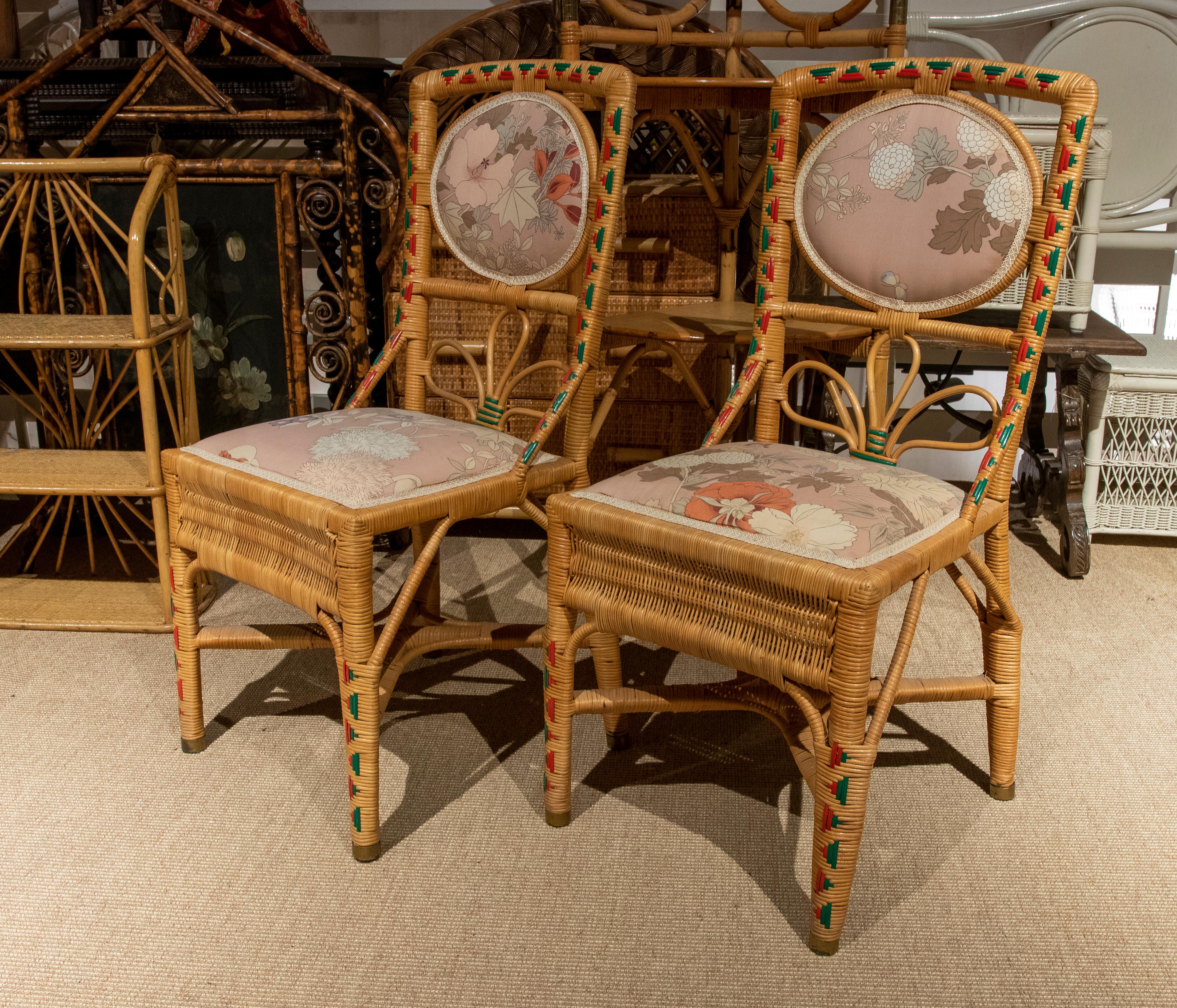 French pair of handmade Wicker chairs with colorful decoration.