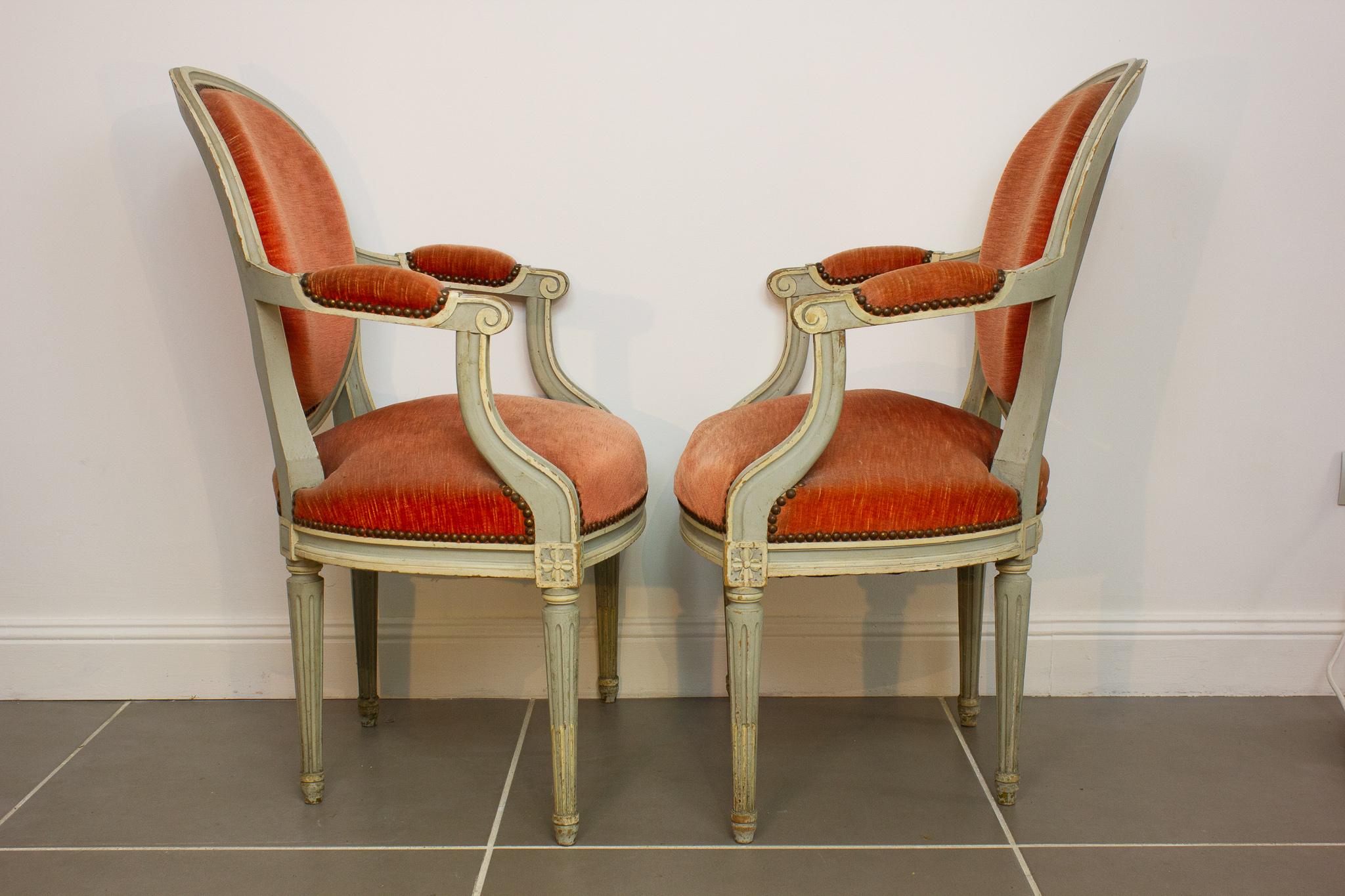 Charming pair of Louis XVI style medallion armchairs dating from the 1950s. The base is typically Louis XVI fluted and tapered. The legs are connected to the seat by dice sculpted with flowers. The armrests are sculpted with pleasure. They are