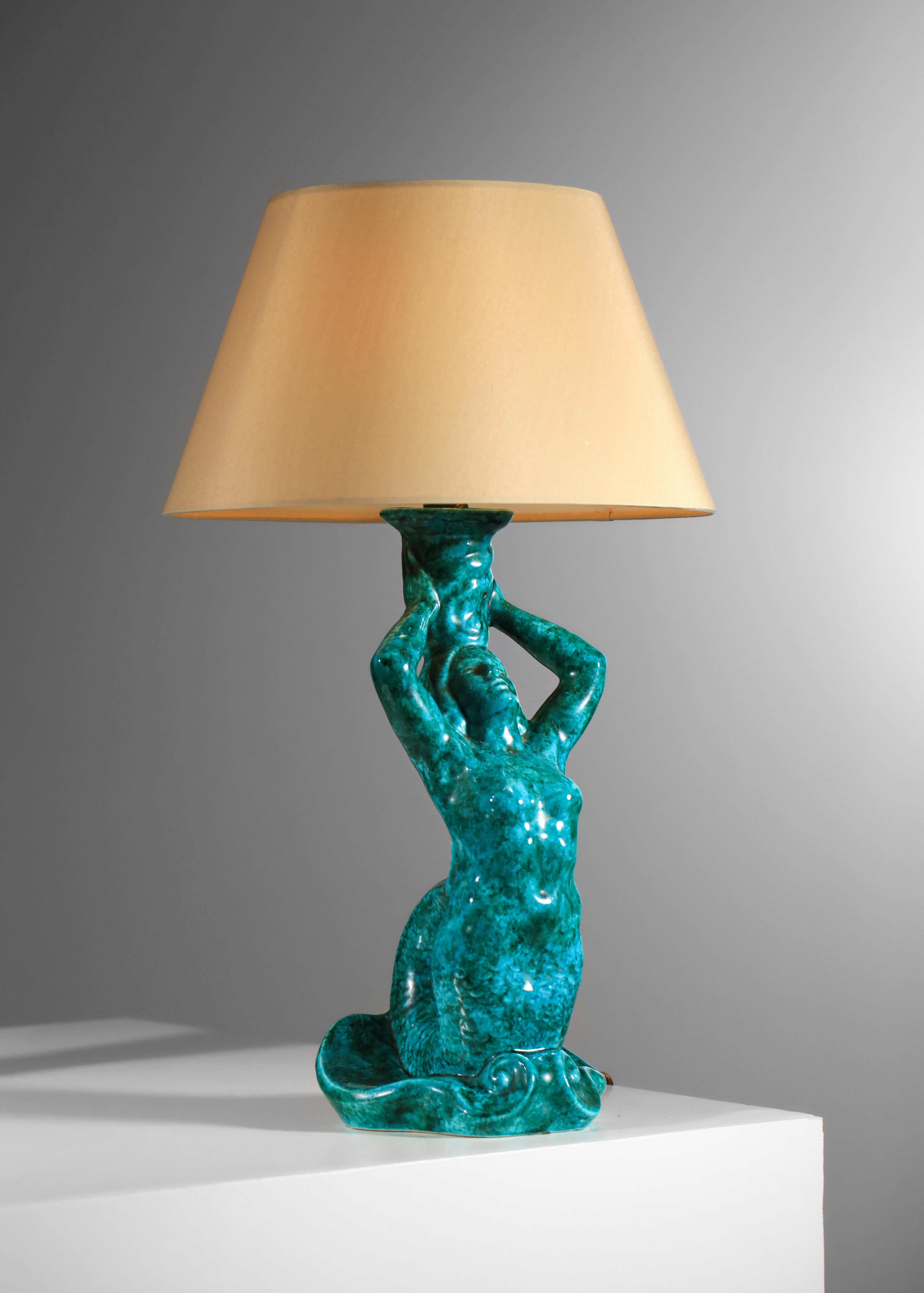 Pair of French table lamps from the 50s. Glazed earthenware bases in blue/green hues depicting a mermaid. Very decorative lamps, signed under the bases. Electrical system refurbished with original sockets, LED B22 bulbs recommended. Very nice