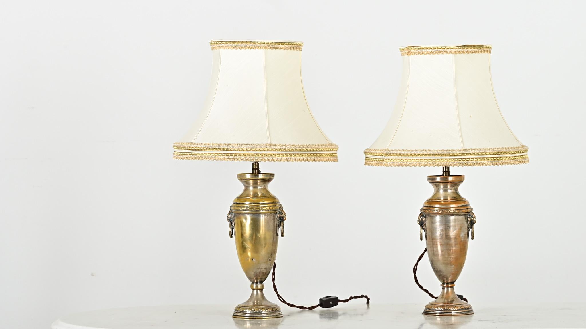 Un par de pequeñas lámparas de mesa francesas de plata de principios del siglo XX, de sobrios y refinados elementos decorativos sobre esbeltas formas de urna, que harán las delicias en un bufé o en mesillas de noche. Su estilo neoclásico es