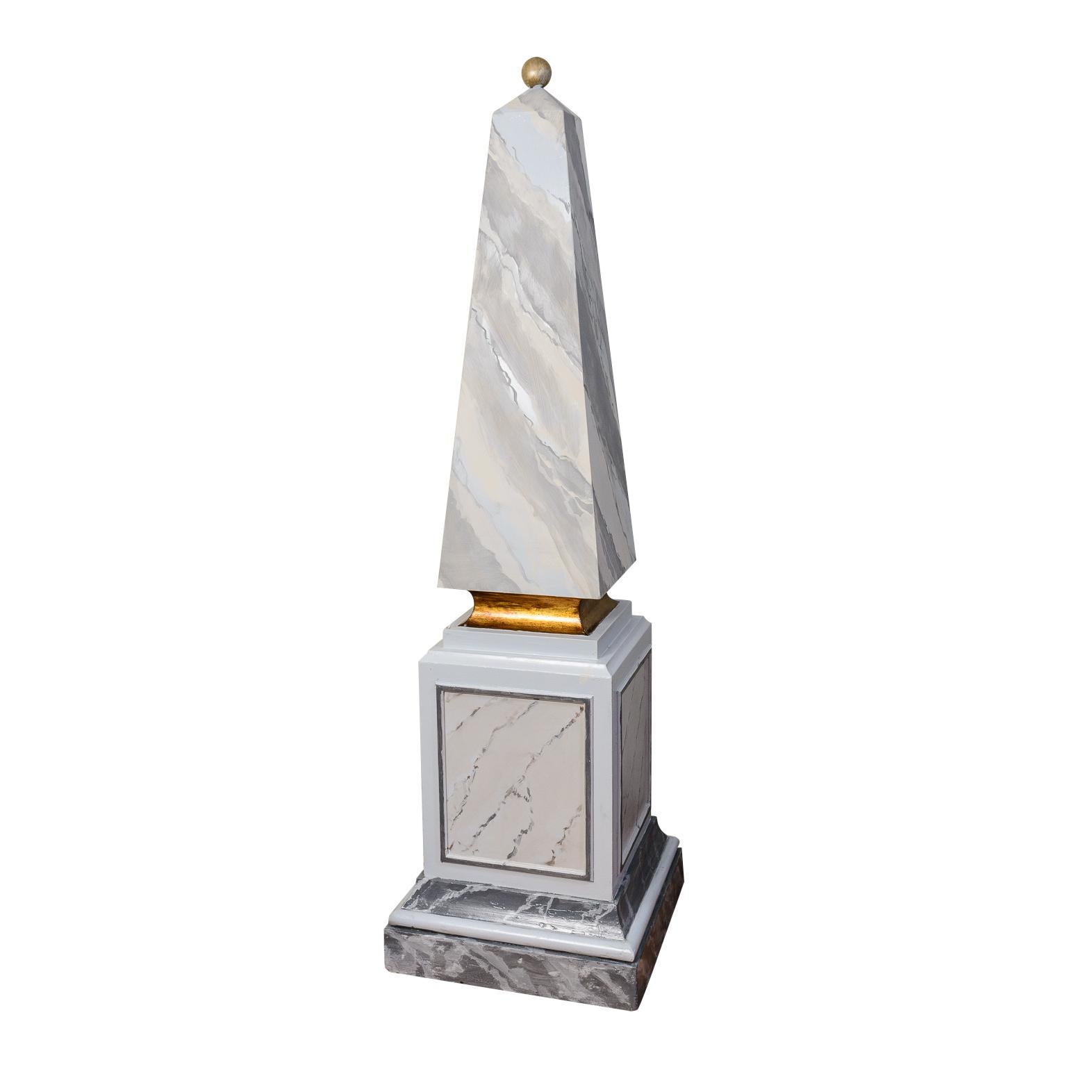 This is a very elegant  Pair of Painted Wood,  Faux Marble Obelisks from France.
The obelisks stand on a large square base with moldings and cartouches all around.
Topped by a gold color ball
The wood is old is very old.
The original owners brought