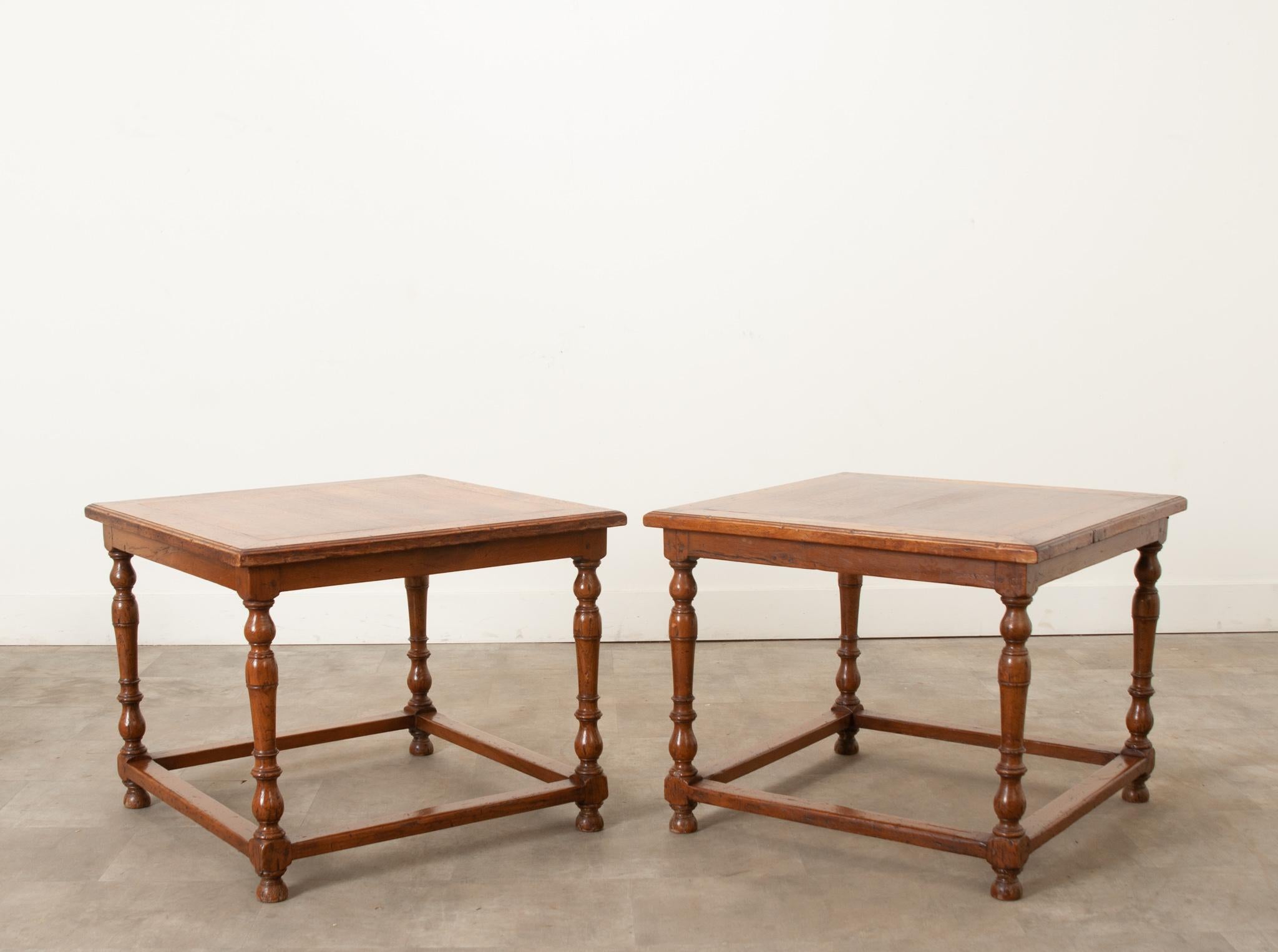 This pair of square ends tables are built of solid oak with wood peg construction. The large square size of this pair of tables make them perfect for flanking a sofa or using as a coffee table. Turned oak legs are connected by a stretcher making