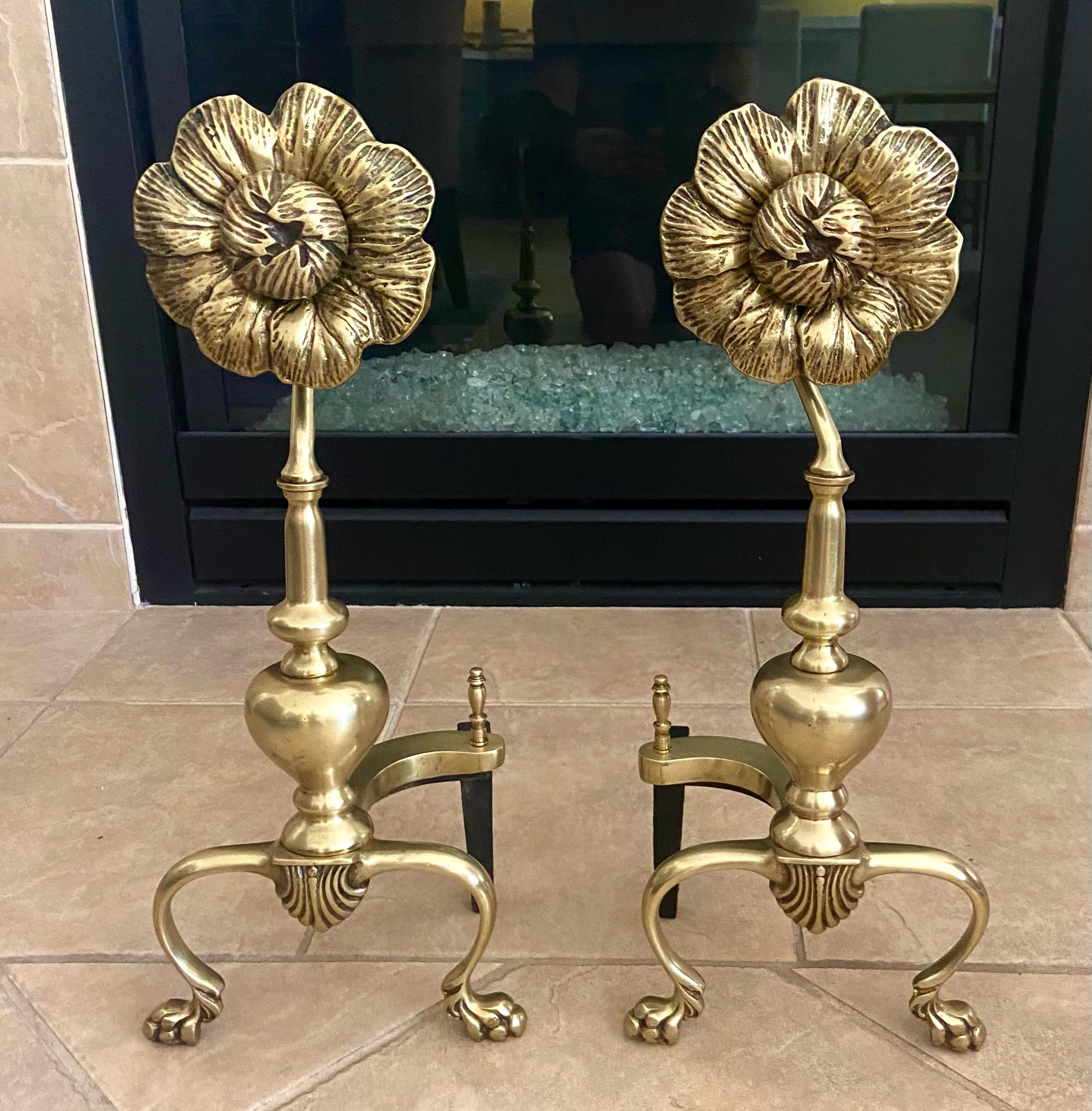 Pair of 1950s solid brass sunflower fireplace andirons. Stylized flower motif with nice detailing including paw feet. Recently cleaned and polished.