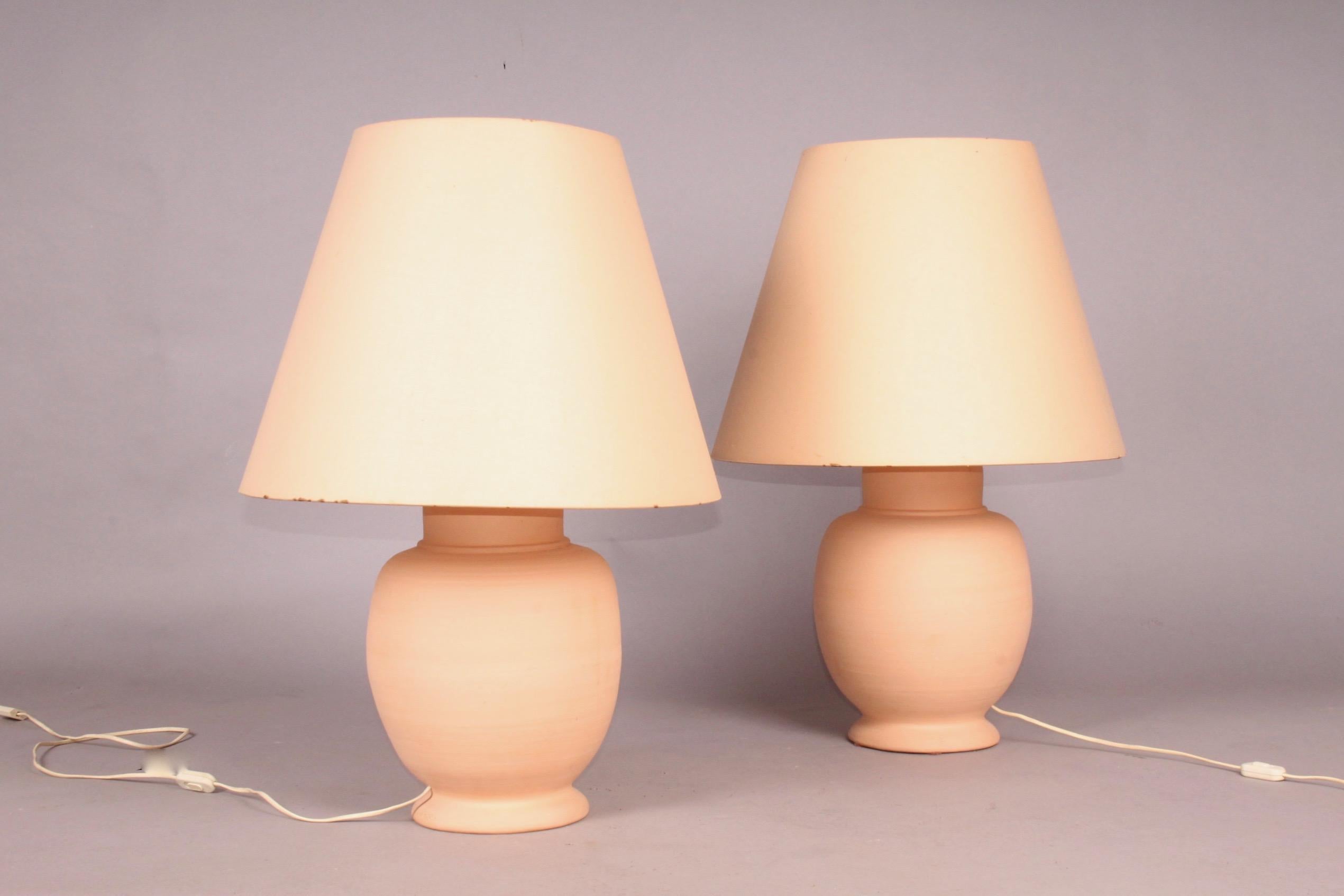 French terre cuite pair of table lamp, marked under the base Fait main au tour, dimensions with out shade height 48, diametre 27 cm.