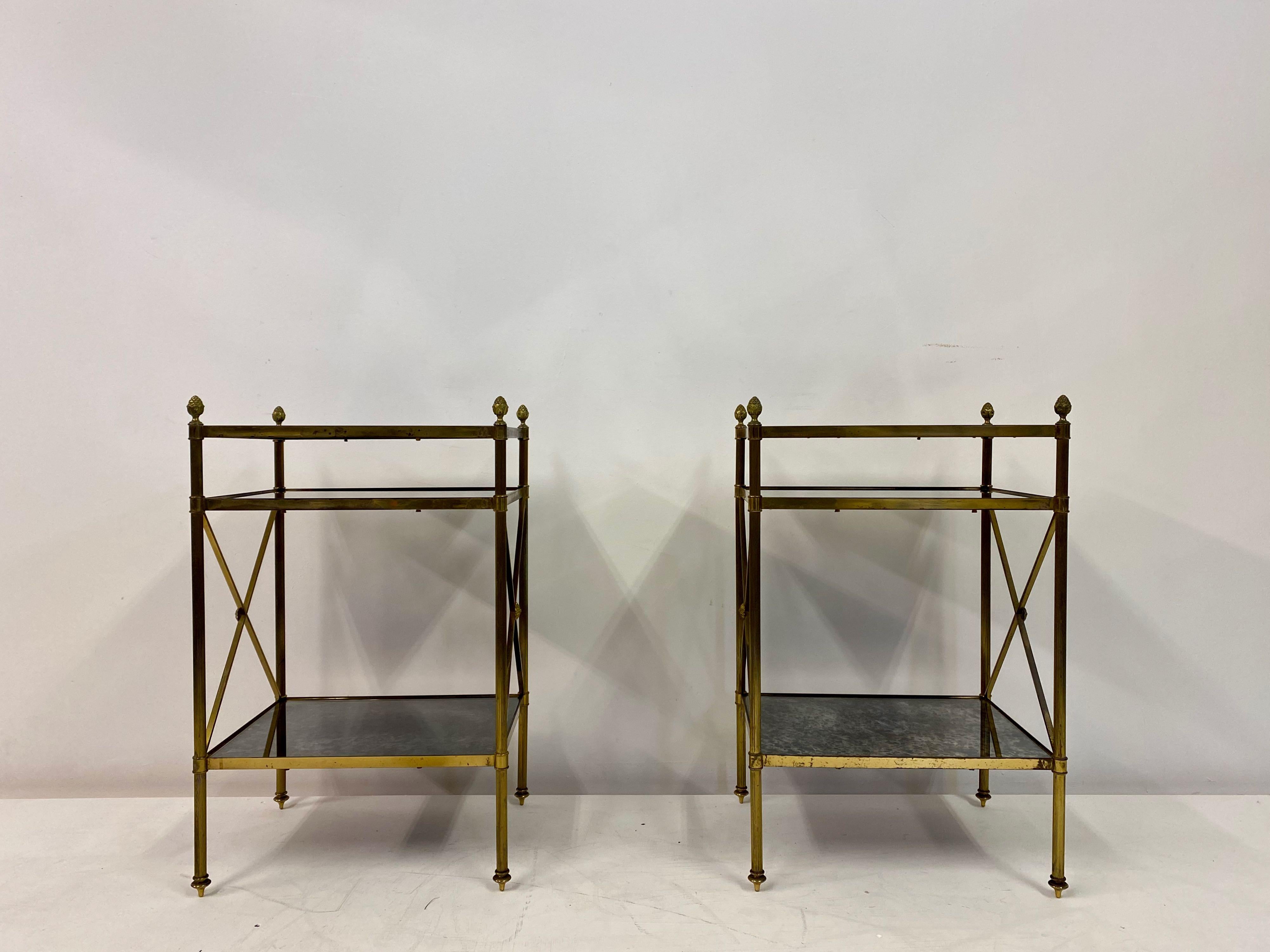 Pair of side table étagères

Three tier

Brass and églomisé glass

Reeded legs

Unusual feet and pineapple finials

French, 1950s.
  