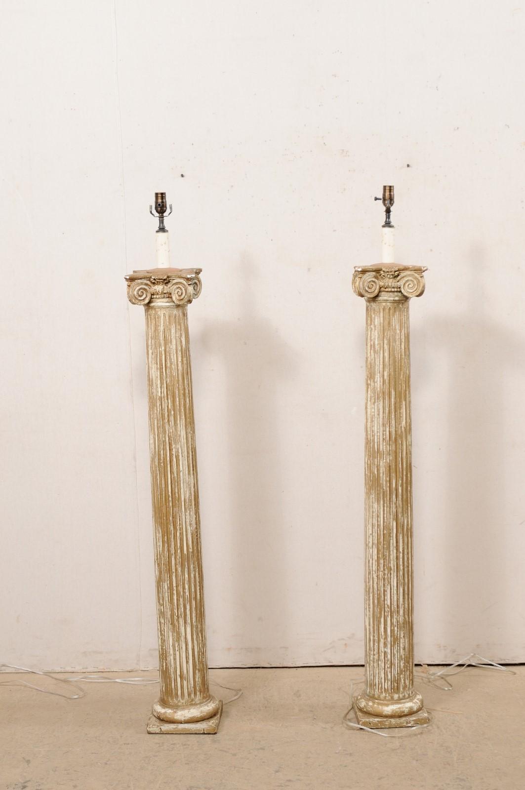 A French pair of single-light floor lamps created from 19th century ionic columns. This lovely pair of floor lamps from France have each been fashioned from antique ionic columns, with rounded and flute-carved bodies, with scrolling upper