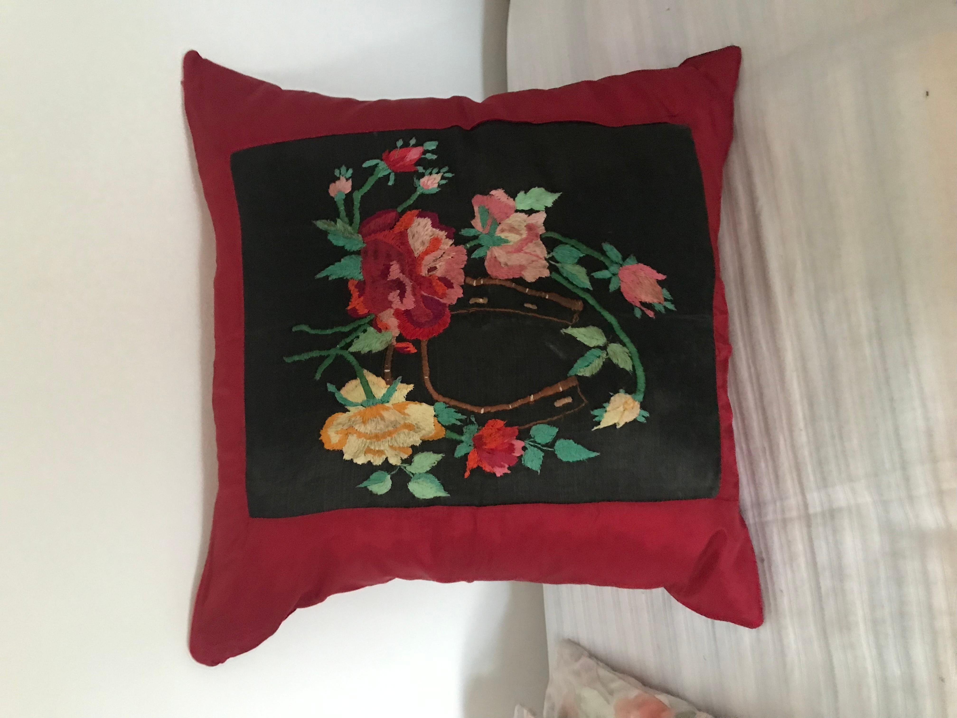 Antique floral embroidery incorporated into a vine red silk pillow with feather insert. 