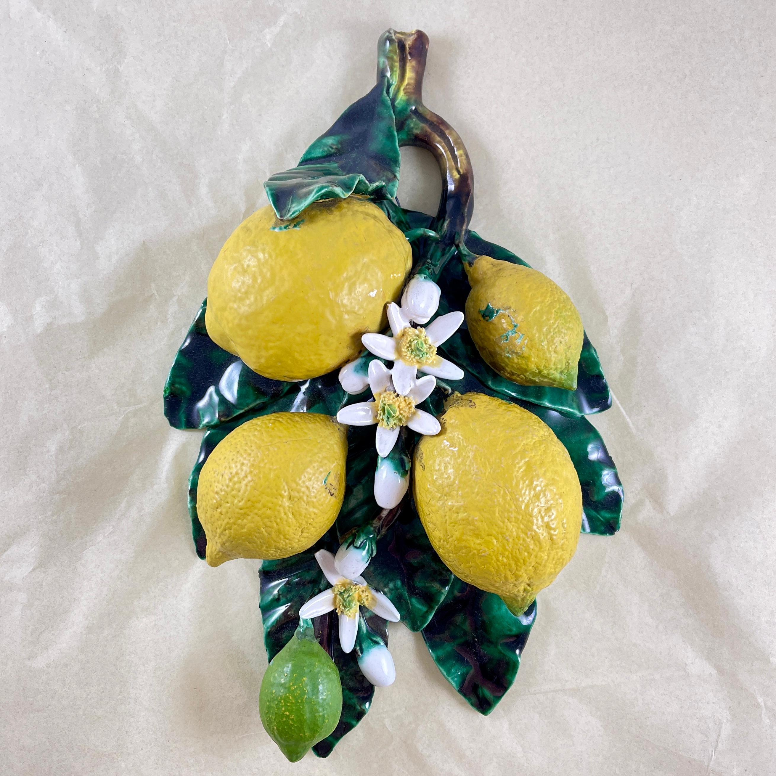 In the manner of Trompe L’oeil, a French Barbotine wall plaque modeled by Eugène Perret-Gentil à Menton, la Cote d’Azur, France, circa 1880.

The trompe l’oeil wall plaque features the lemons grown on the Côte d’Azur. A triangular form plaque made