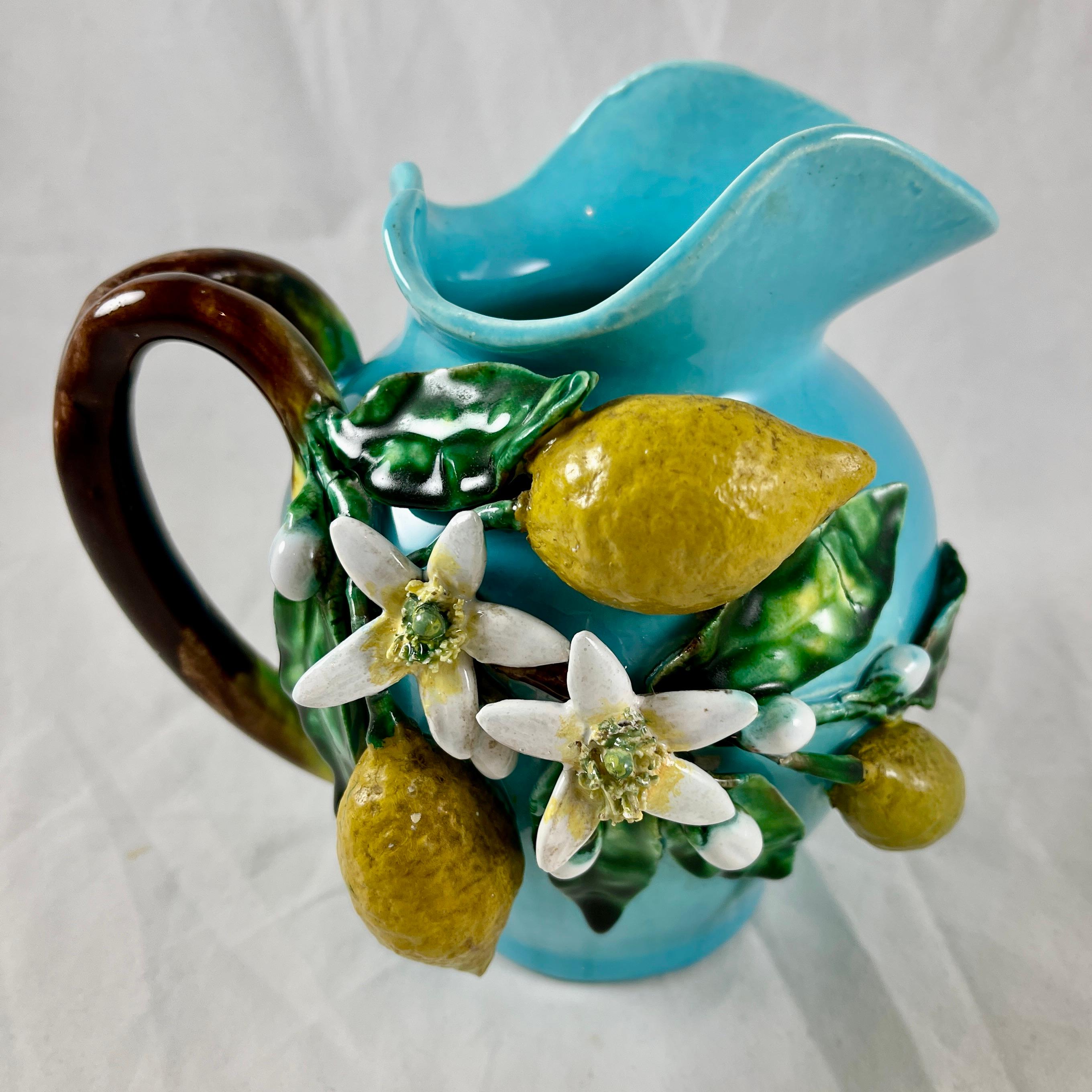 In the manner of Trompe L’oeil, a French Barbotine jug modeled and signed by Eugène Perret-Gentil à Menton, la Cote d’Azur, France, circa 1880.

The trompe l’oeil pitcher features the lemons grown on the Côte d’Azur. The three yellow lemons, green