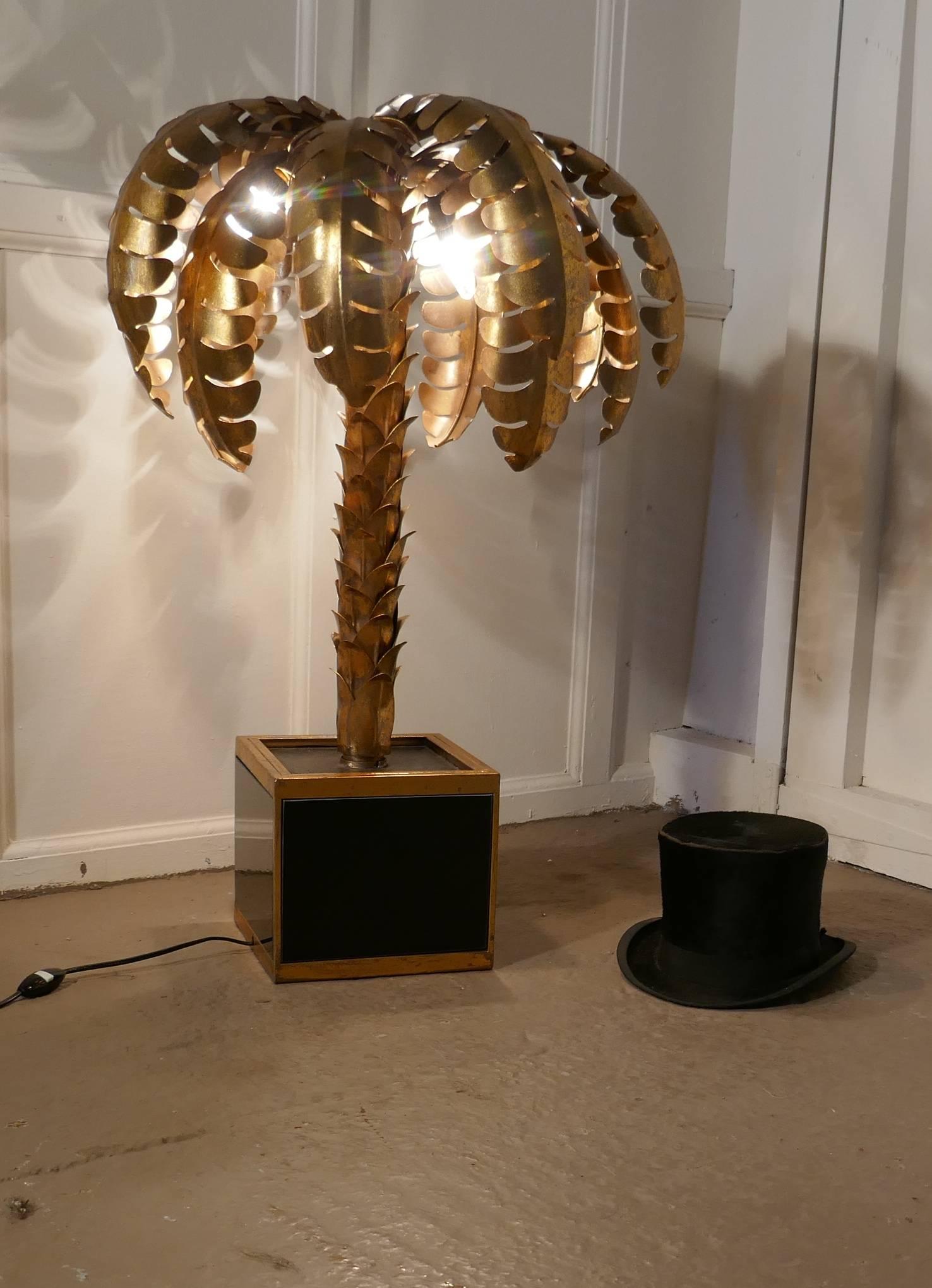 French palm tree tole ware table lamp from Maison Jansen, circa 1970

This stunning piece of Maison Jansen design is in good condition, the lamp has a gilded finish which has a good patina and the electrics work well
Though rare as it is a