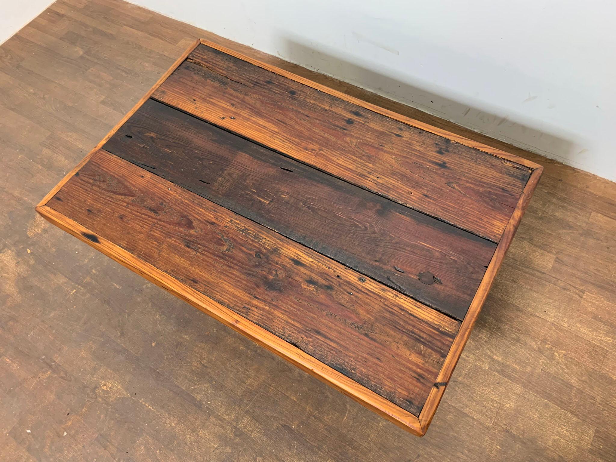 A vintage coffee table fashioned from a wicker laundry basket with a pantry board lidded top, circa 1970s.
