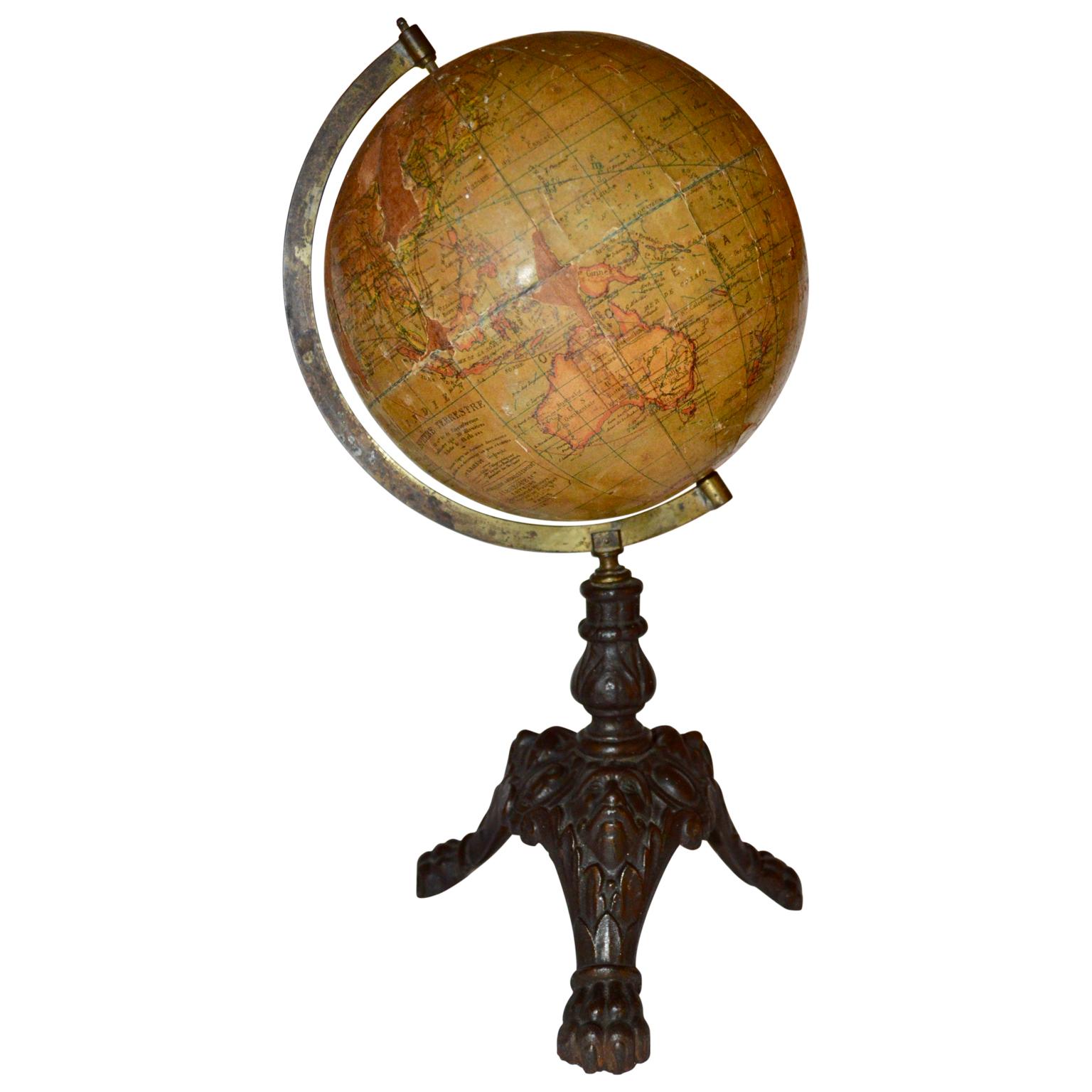Late 19th. century or early 20th century papier-mache terrestrial globe by J. Lebeque et Cie, 30 rue de Lille, in Paris. It has a cast iron paw feet.