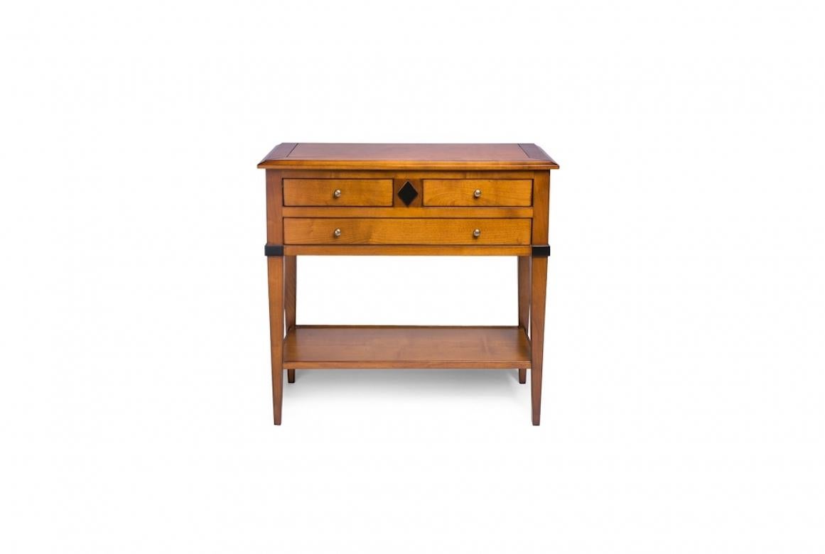 A stunning French Paquet bedside table, 20th century.

Paquet is a Directoire bedside table, shown in cherry wood with a Honeycomb finish and details in Ebonised Wood. It features three drawers and a lower shelf, and it has elegant knobs in