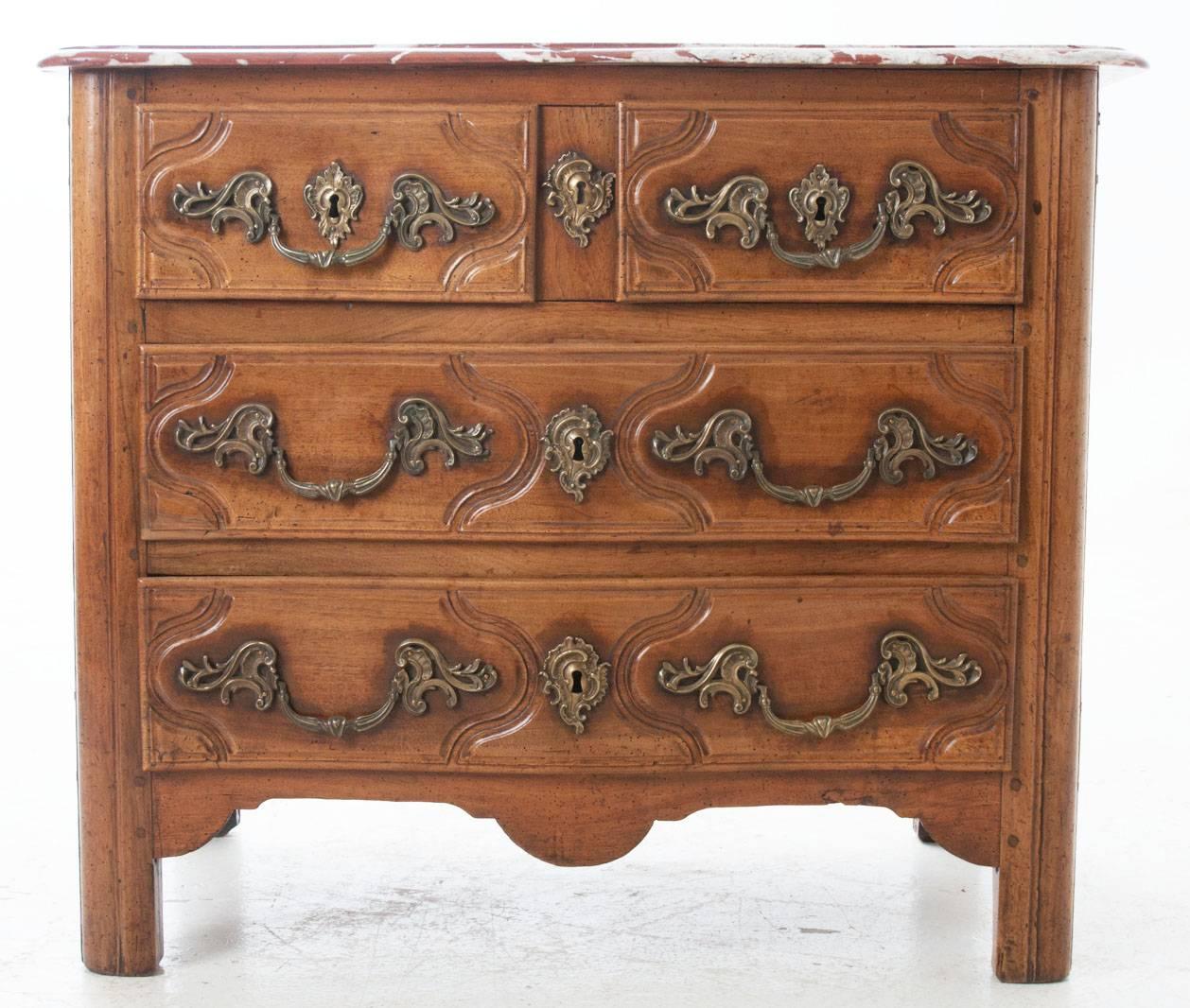 French fruitwood Parisian Regence rustic marble-top commode, circa early 1700s.
The shaped marble top over two small raised and recessed panel drawers above two long raised and recessed panel drawers. The shaped apron raised on rounded rectilinear