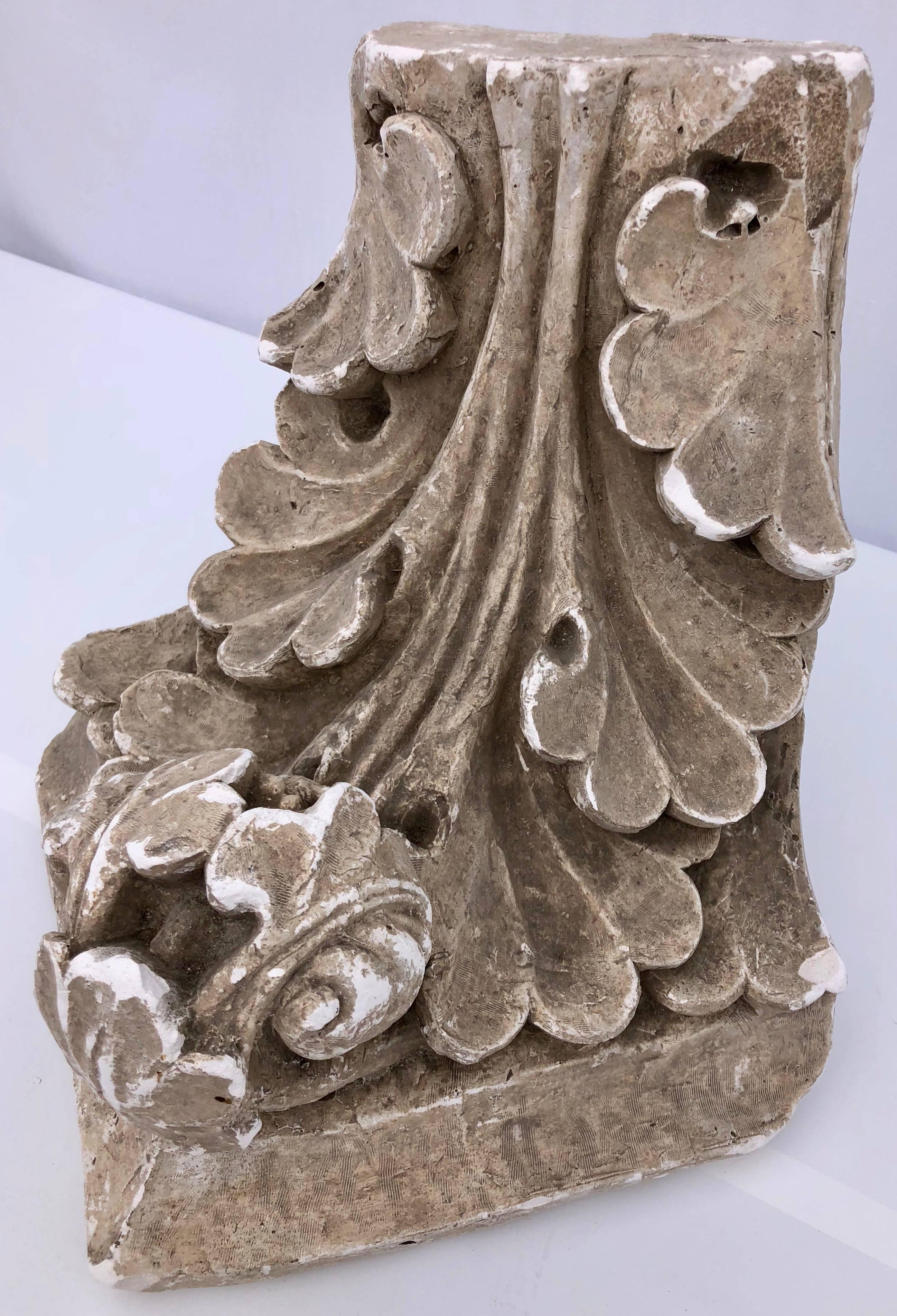 This heavy French plaster corner wall sconce is from the early 1900s and comes from a Paris architectural school. It is in a Corinthian style with a scroll design and has an Inscription 