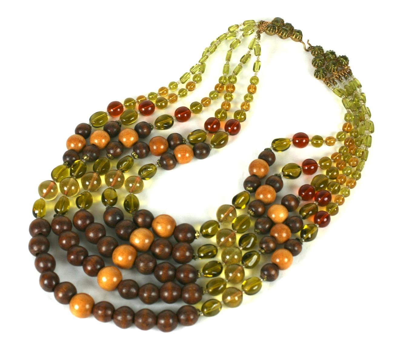 Attractive and unusual French multi strand necklace composed of five strands of  amber, topaz and citrine pate de verre vari sized round beads with natural wood bead stations. 
Nice scale with ornate beaded clasp. Excellent Condition, Made in