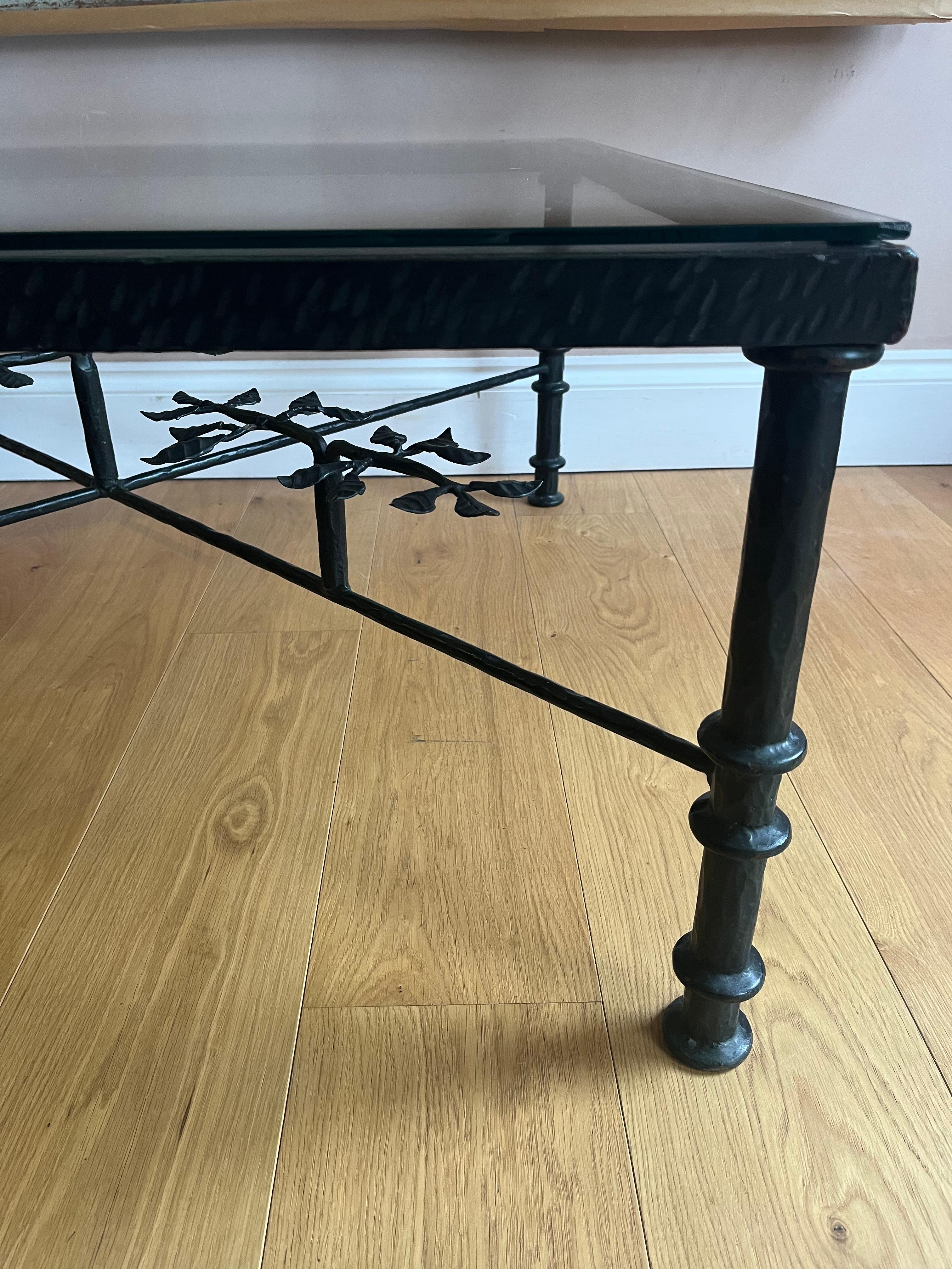 An elegant late 20th century iron and glass coffee table with leaf detail. Inspired by Diego  Giacometti. Glass is toughened. 