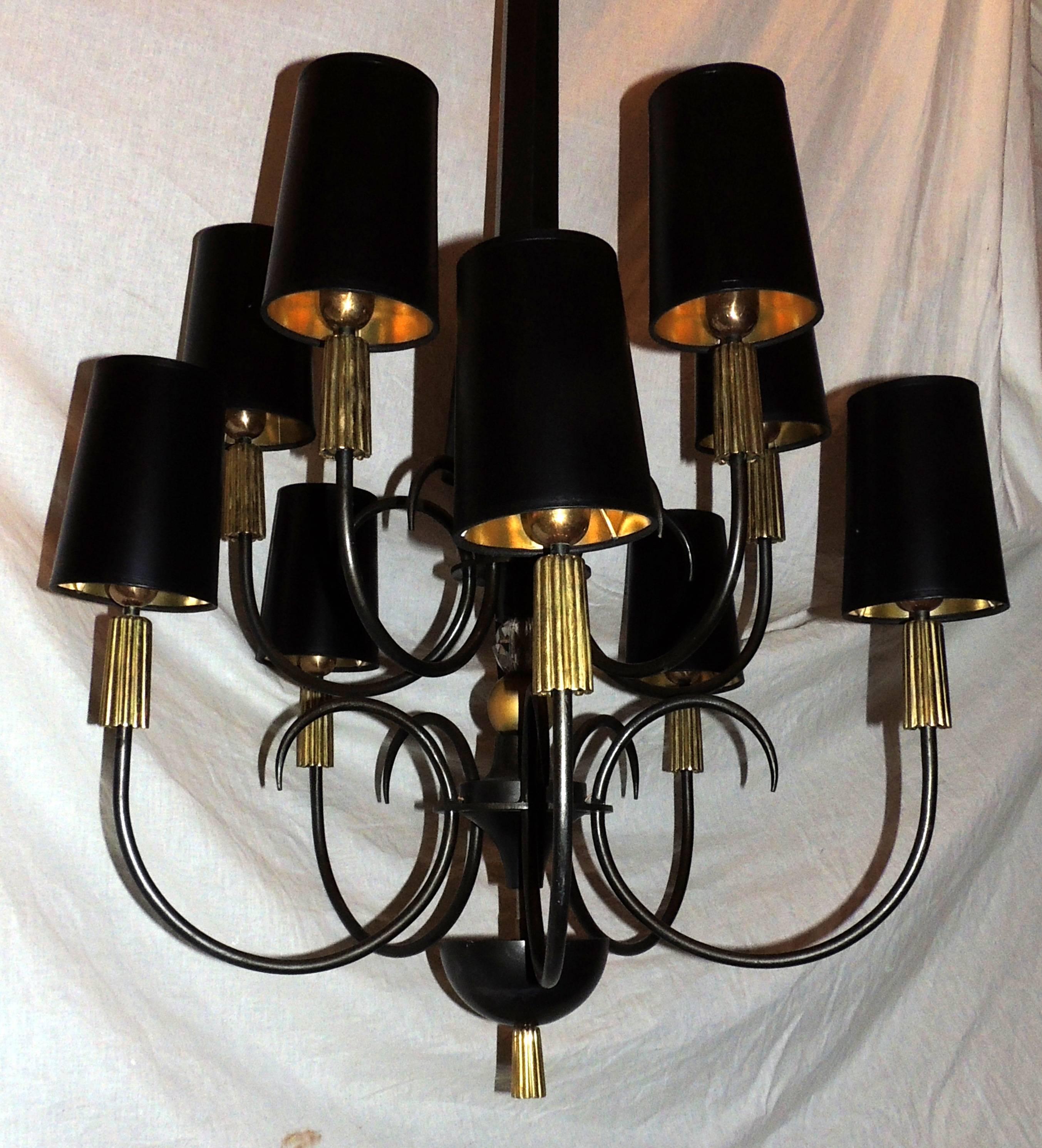 A wonderful French Empire style patinated and gold gilt Regency bronze and iron chandelier with crystal ball center with ten-arm and two interiors up lights.
This fixture is so impressive in person with its eclectic modern flair it could work in