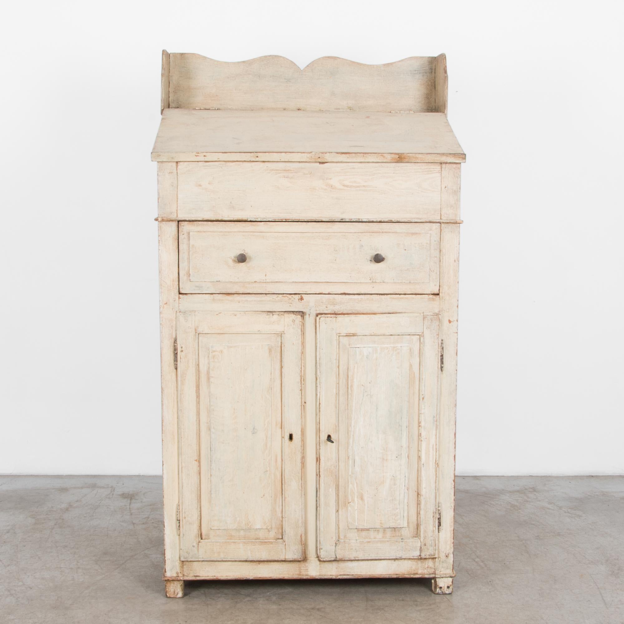 A hardwood secretary cabinet from France, circa 1900. This two-door cabinet features a unique tall desktop. A wooden surround is carved with a subtle scallop, enhancing the patina and shape, casual yet elegant with time worn rustic charm.