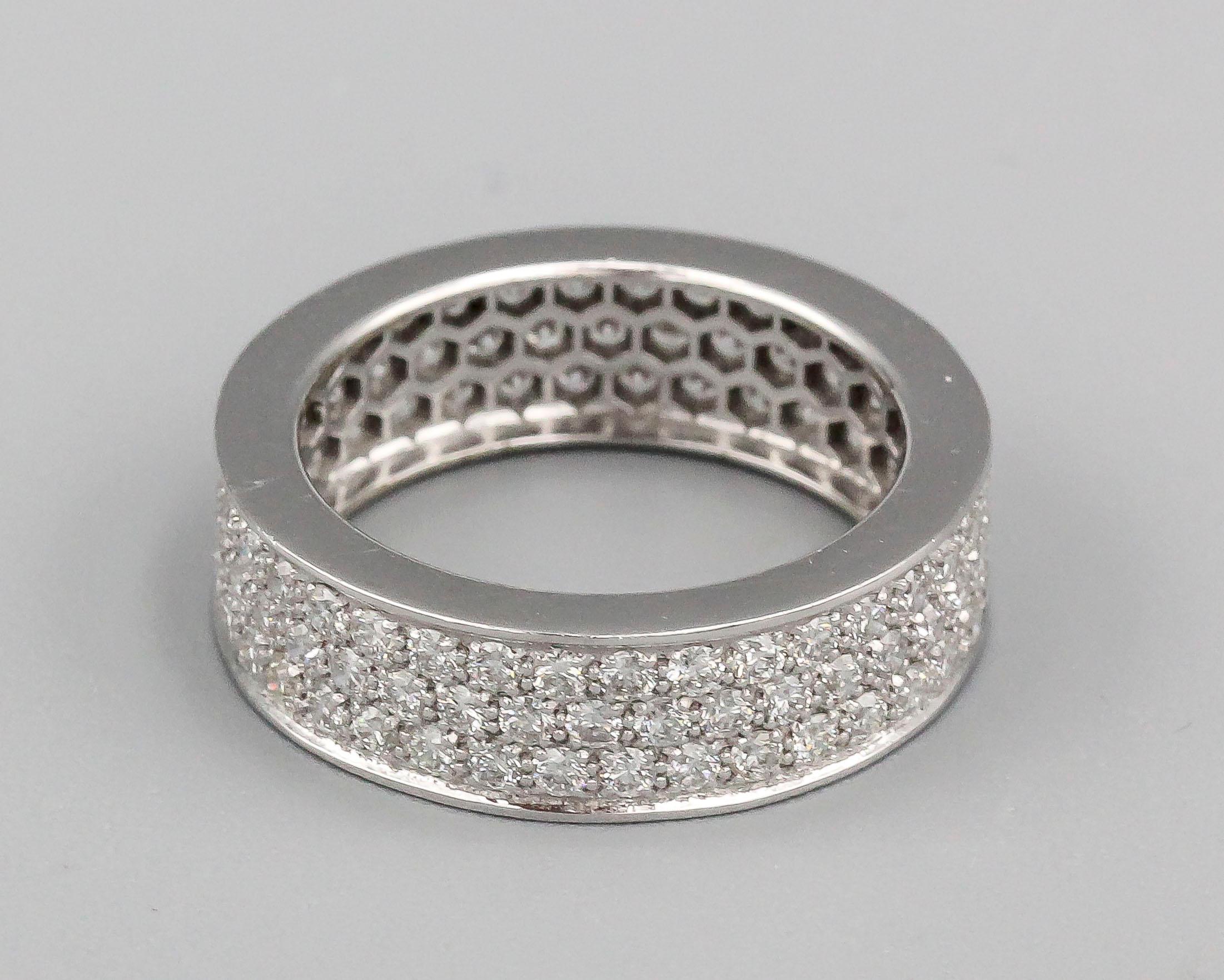 Fine diamond and 18k white gold band of French origin and contemporary make.  Features approx. 2.50 carats of round brilliant cut diamonds of approx. G-H color and VS approx. clarity. Size 6.25 and approx. 6 mm wide.

Hallmarks: Maker's mark, French